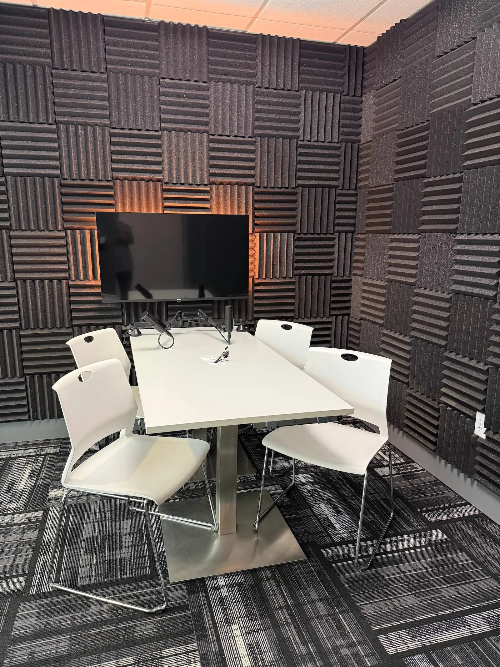 Podcast room with white table and chairs