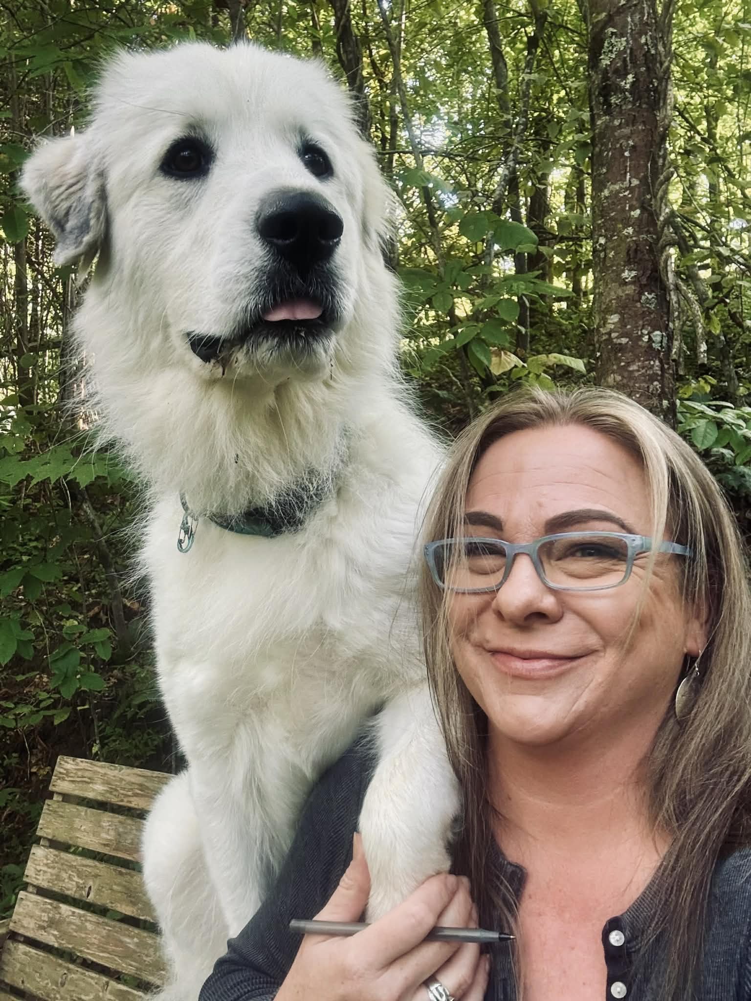 Kim Brophey on the right and a young flock guardian on the left are sharing a bench