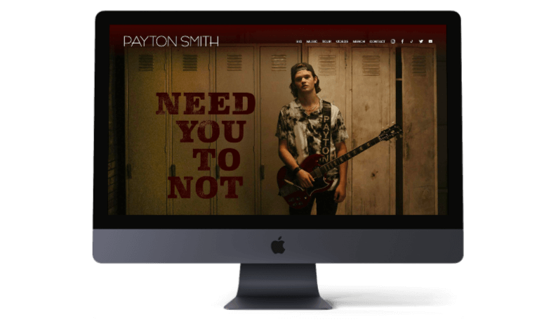 Image of Country artist payton smith, holding a guitar and standing in front of lockers - zoobymedia.com - nashville squarespace design