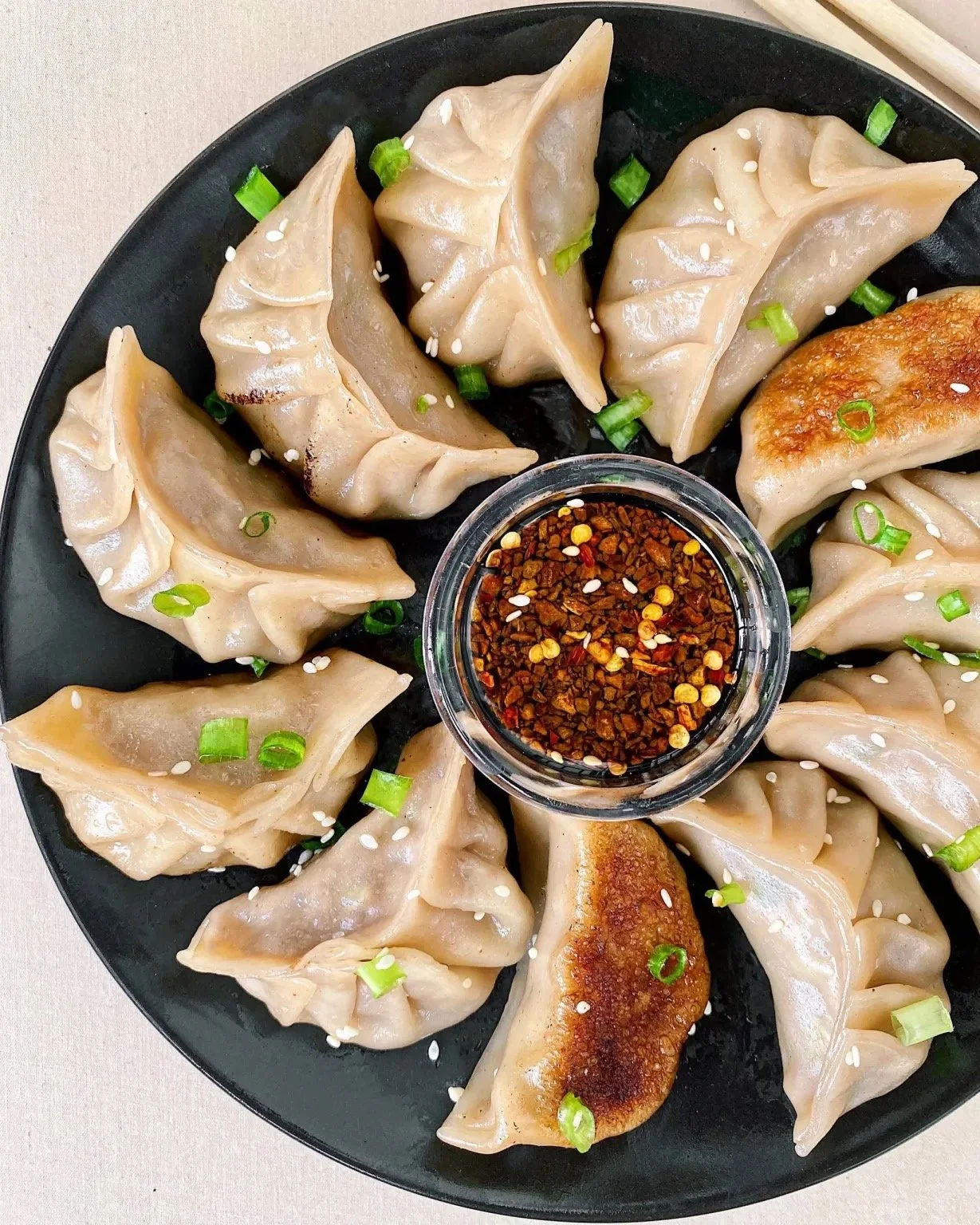 These pan fried pork dumplings are easy to make, once you watch Maggie show how to fold them! These are filled with ground pork, napa cabbage, green onions, garlic, ginger, and a lot of flavor