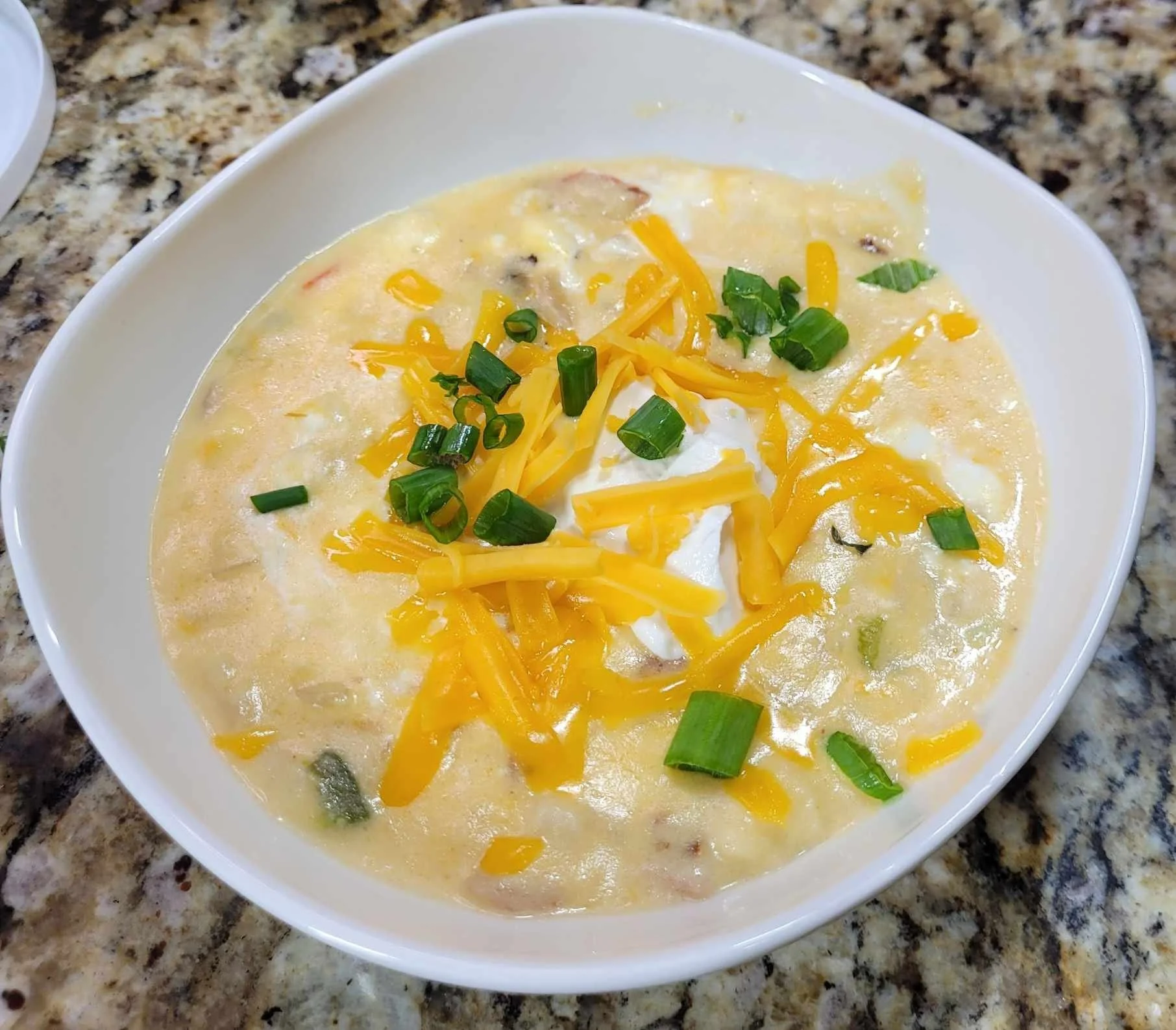 This comforting, cheesy soup is made with frozen hashbrowns, chicken broth, Velveeta, cheddar cheese, peppers, and of course, bacon!