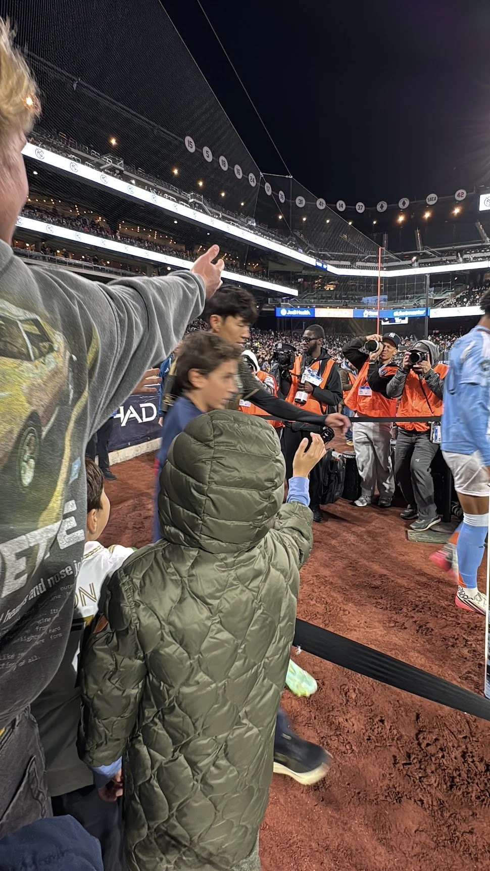 Boy in a Son #7 LAFC jersey at the player walkout as Hugo Lloris high-fives children