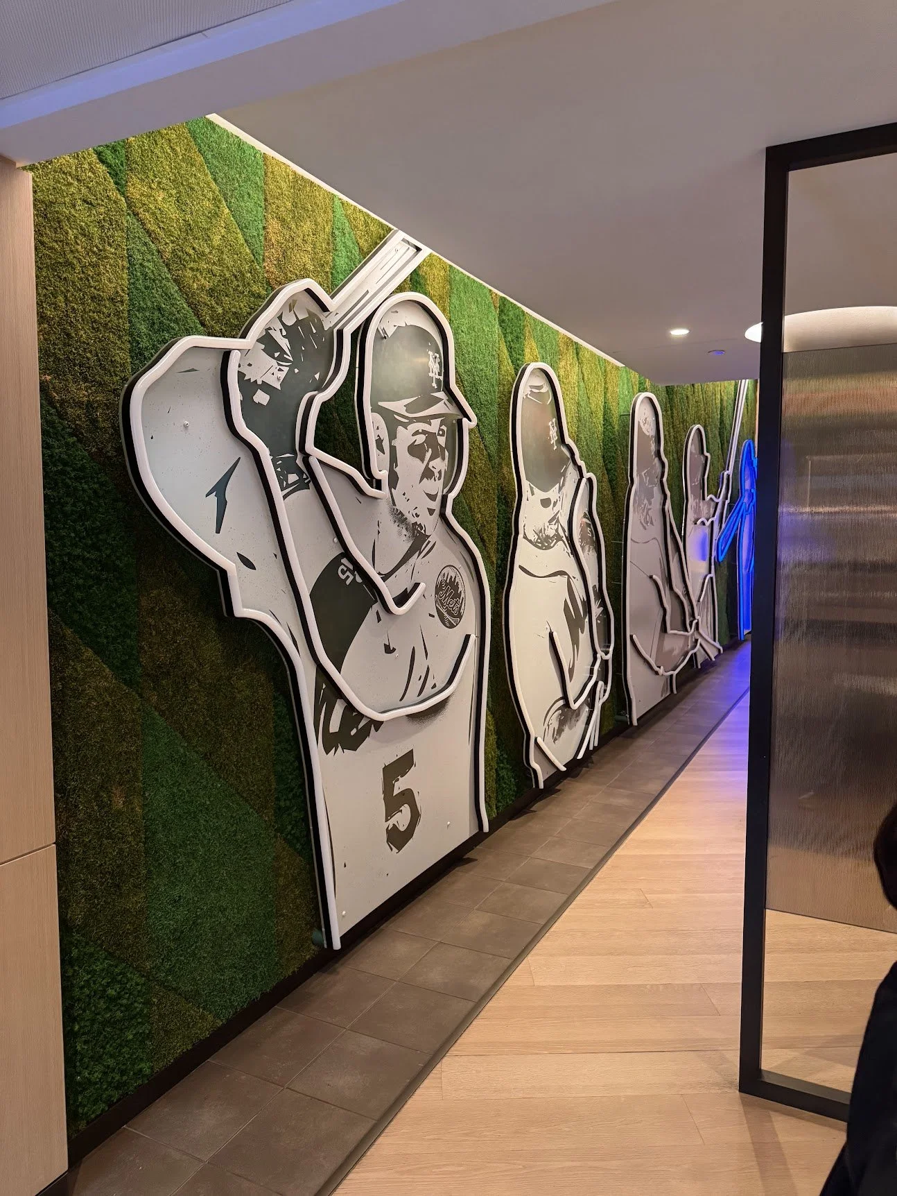 Moss wall with black-and-white portraits of Mets legends, including David Wright's #5, in the Delta Sky360 Club