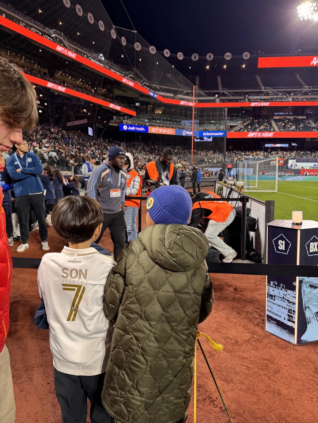 Boy in a Son #7 LAFC jersey at the player walkout as players high-fives children