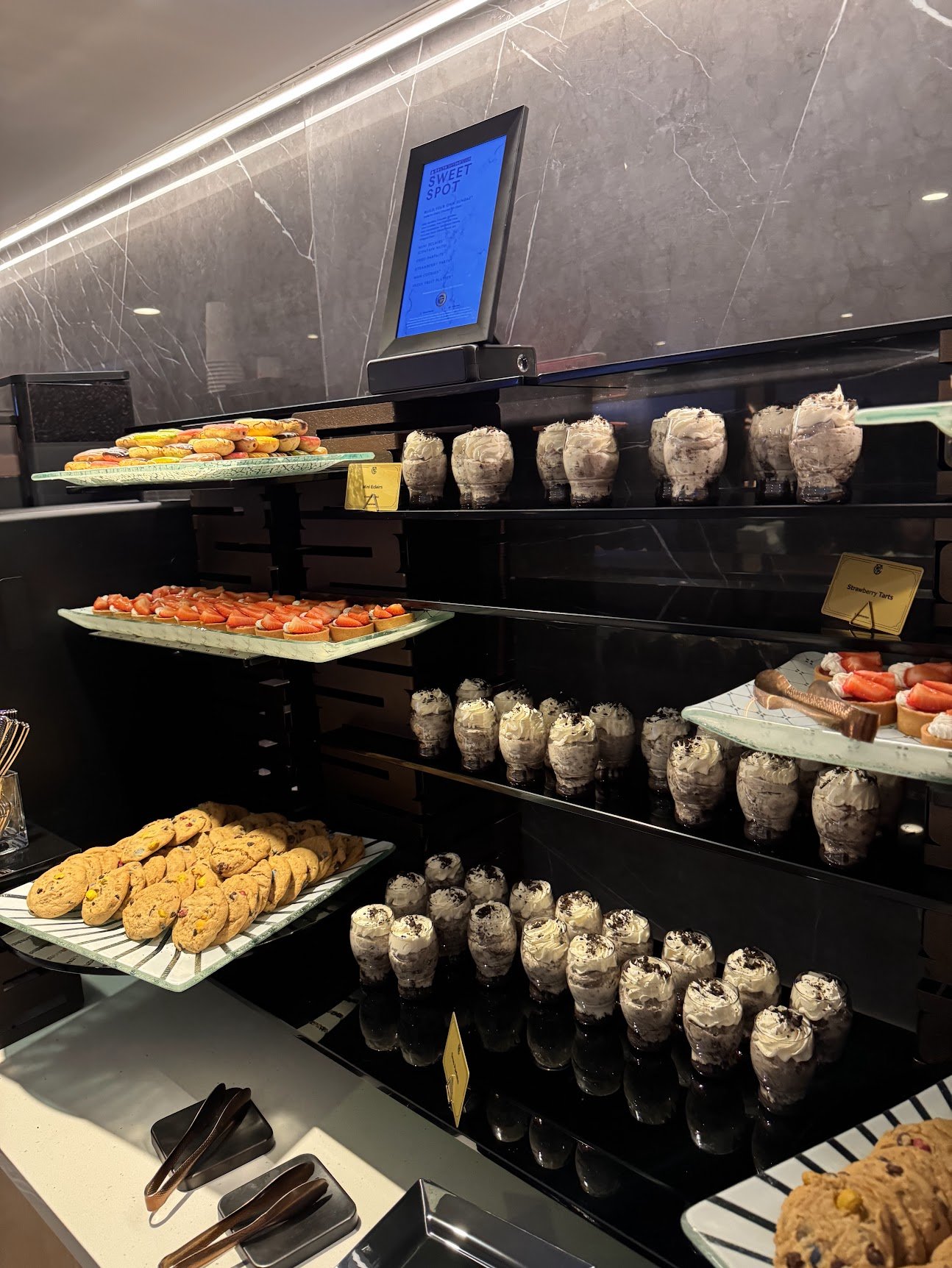 Strawberry tarts, Oreo parfaits, mini éclairs and cookies at the Sweet Spot dessert bar in the Delta Sky360 Club