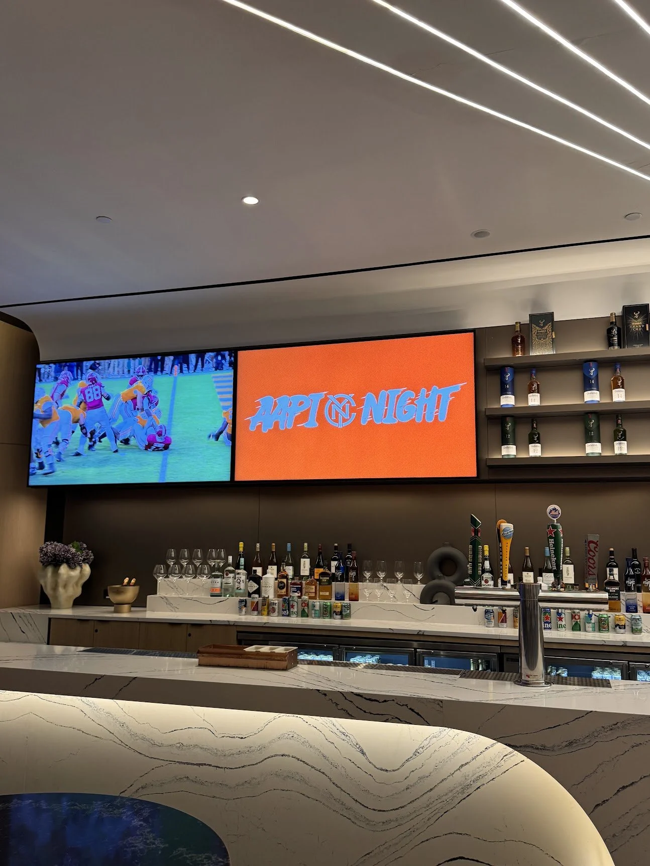AAPI Night graphic on the screens above the bar in the Delta Sky360 Club at Citi Field