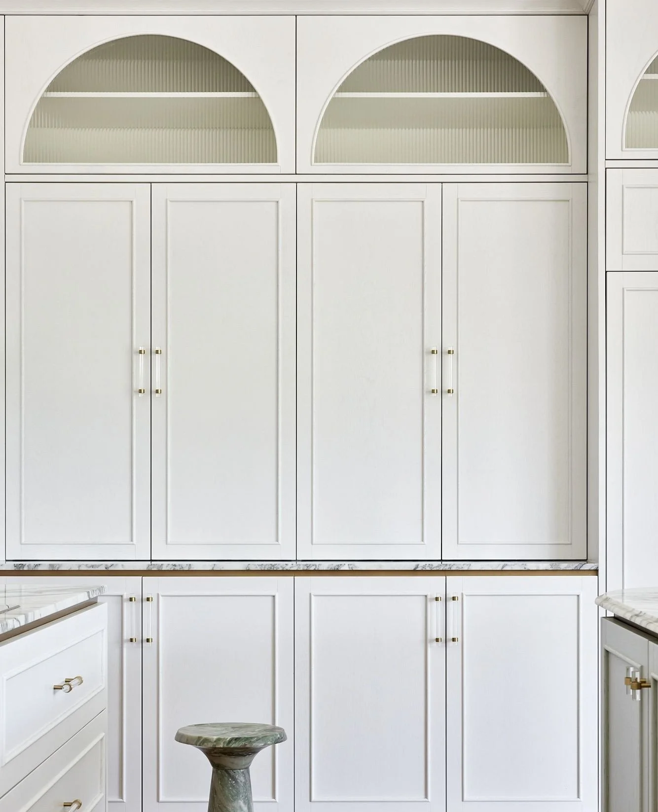 Arched profiles, fluted glass, and refined brass hardware bring a timeless character to this cabinetry, while marble detailing adds a layer of luxury.⁠
⁠
We believe in designing joinery that feels architectural&mdash;crafted not just for storage, but