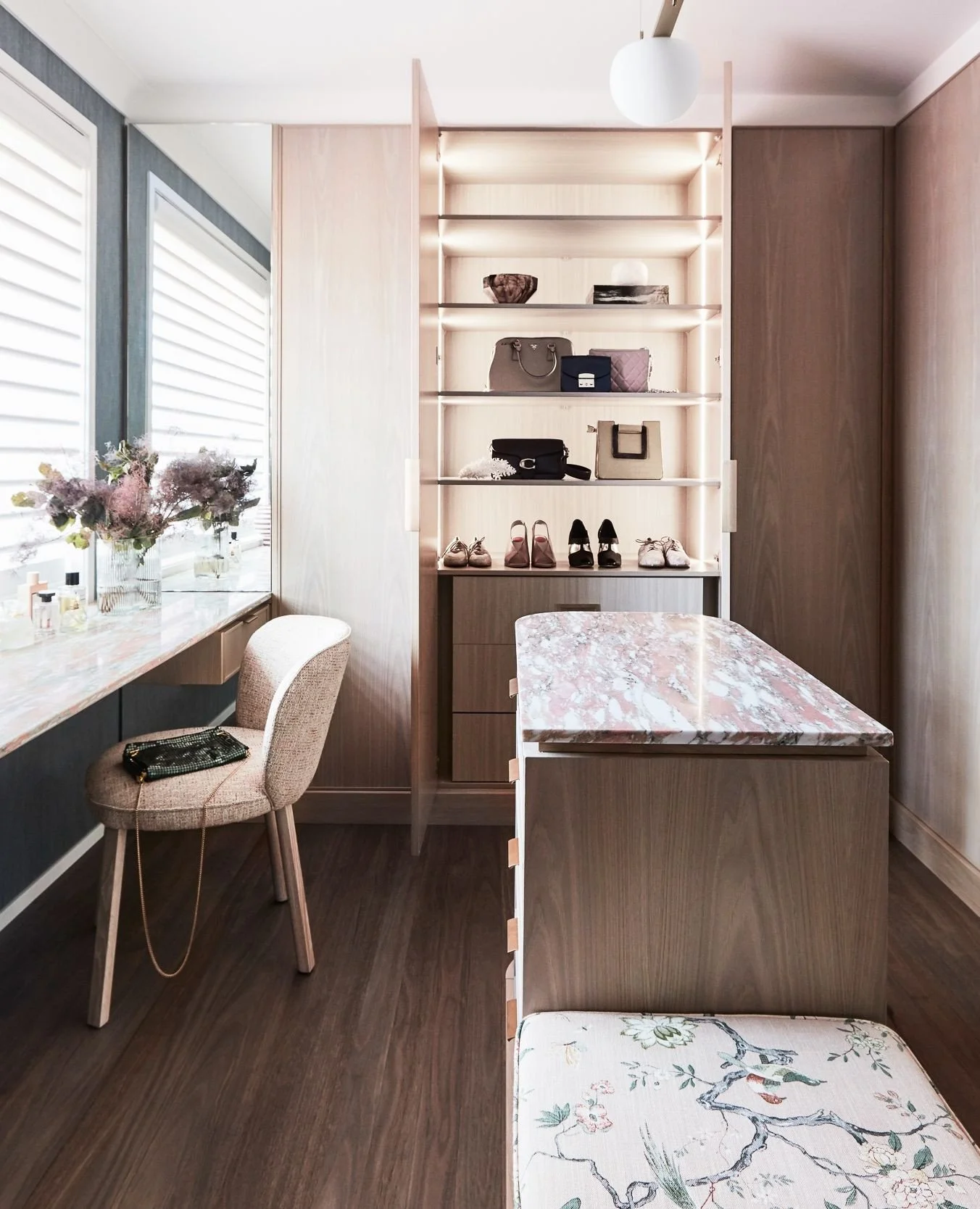 This serene space at Home Low balances functionality with indulgence. Soft timber tones, a feature stone surface, and curated lighting showcase treasured pieces. Every detail is considered, from the tactile warmth of the joinery to the gentle light t