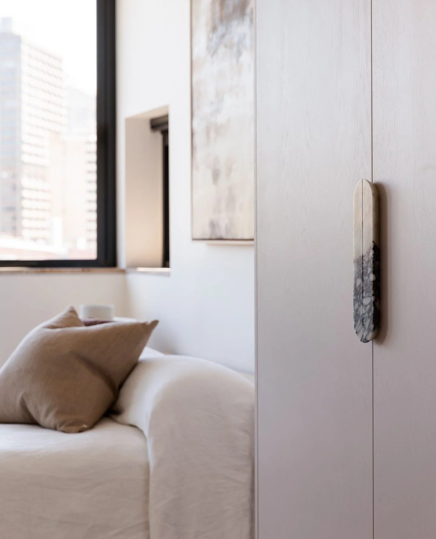 A bedroom designed for quiet reflection.⁠
⁠
Muted pinks and earthy neutrals create a palette that feels cocooning, calm and timeless.⁠
From the custom joinery handles to the artwork that anchors the space, every detail works in harmony to evoke softn