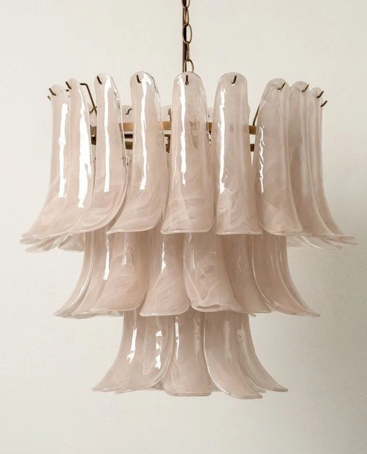 This sculptural glass pendant brings movement and romance into the space. Its fluid petals catch the light in the most delicate way.⁠
⁠
Every room deserves that one piece that feels like art ✨⁠
⁠
Image @pinterest⁠
Lonso taupe chandelier from @lightsa