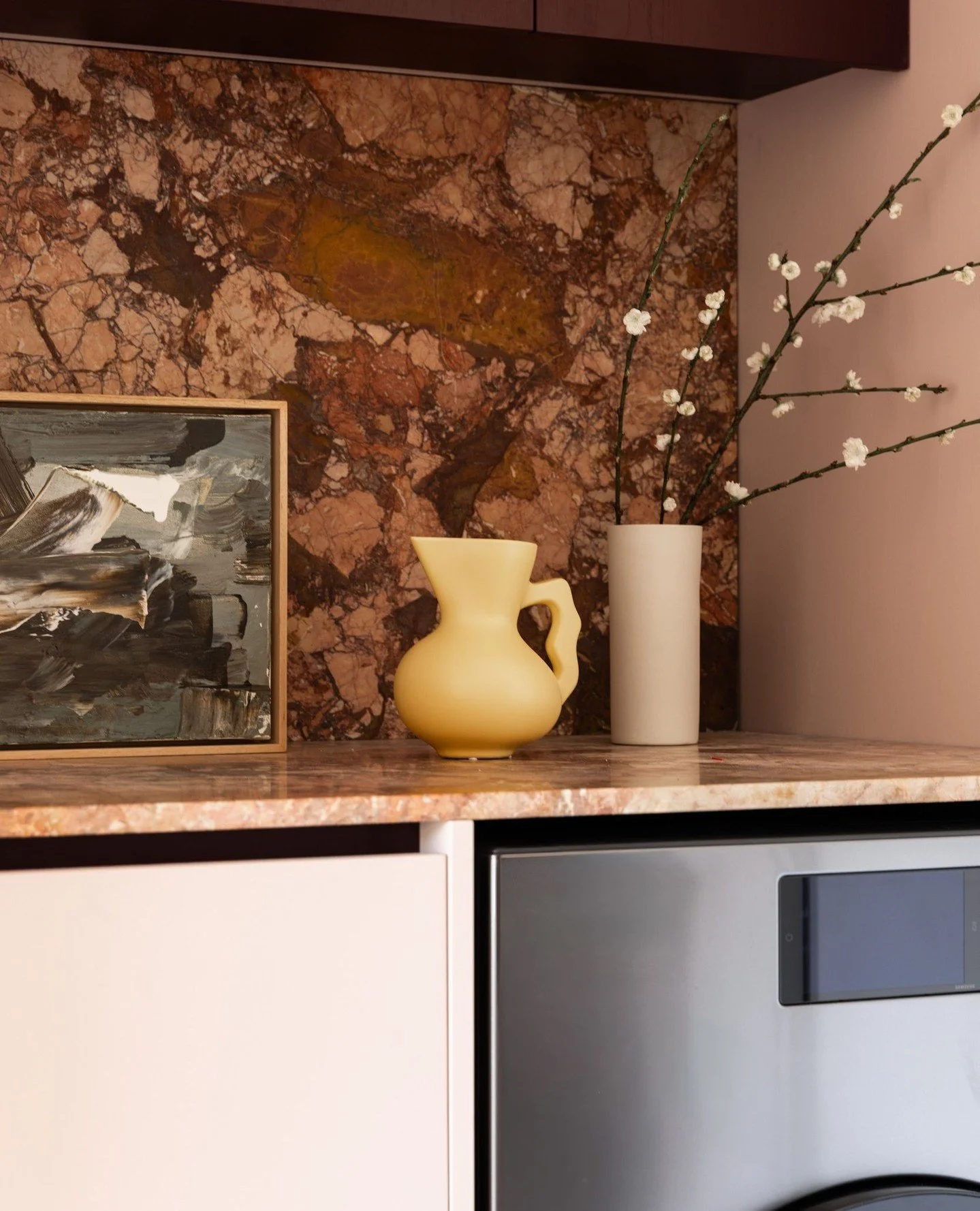 This tucked-away nook balances function with feeling, seamlessly doubling as a laundry and a quiet office zone. Custom joinery keeps everything concealed, while rich stone and warm finishes elevate the everyday. ⁠
⁠
We love that even the most practic