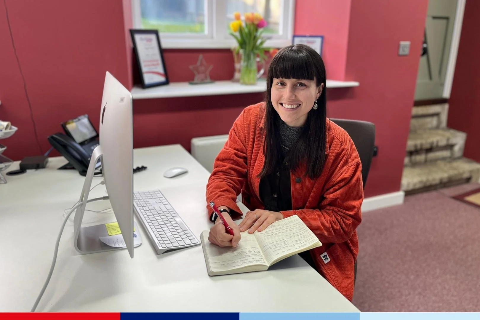 A person sitting at a desk in front of a computer