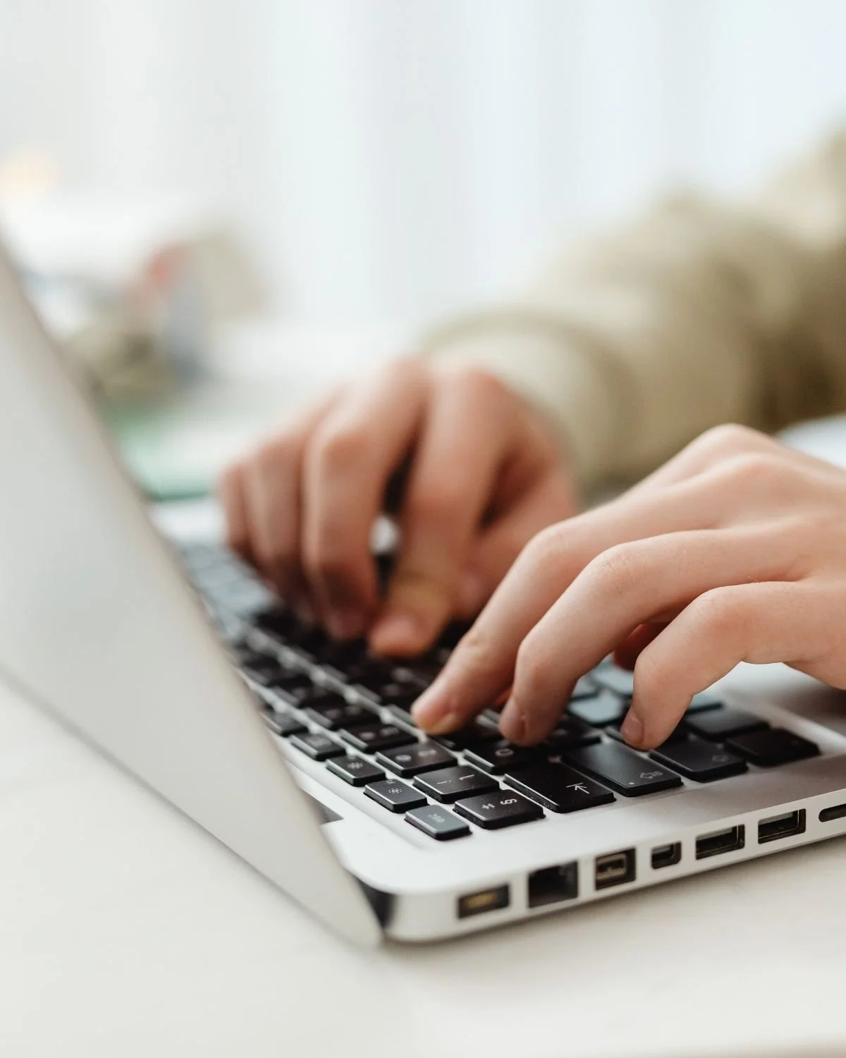 Hands typing on a laptop, representing getting started with professional admin support.