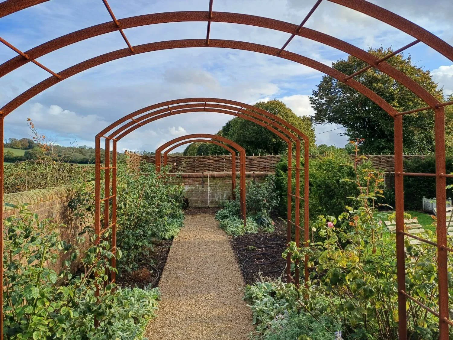 Woven fencing along the top of existing wall to provide screening and wind barrier.