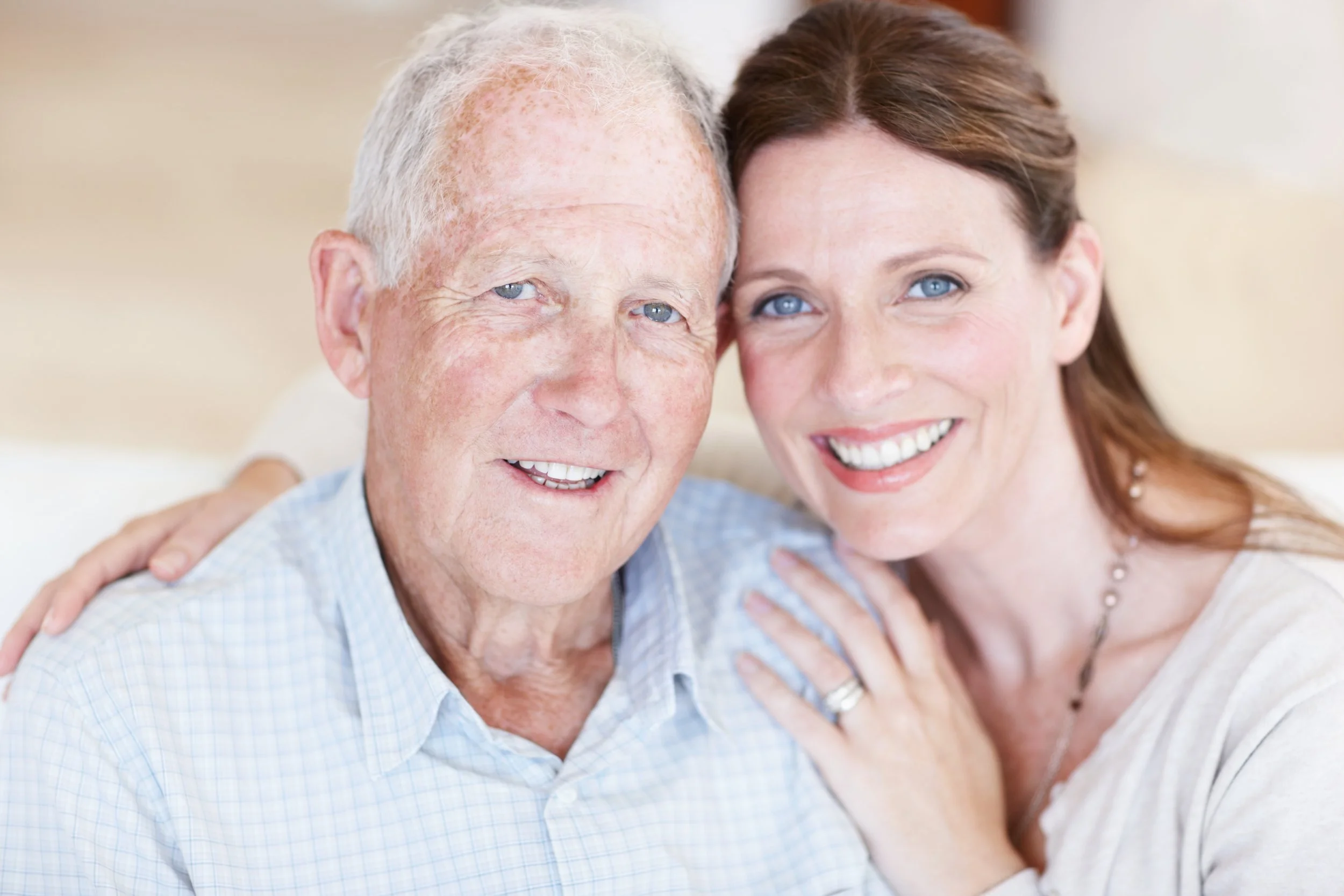 iStock-Elderly dad blue eyes being hugged by daughter long brown hair_163640895.jpg