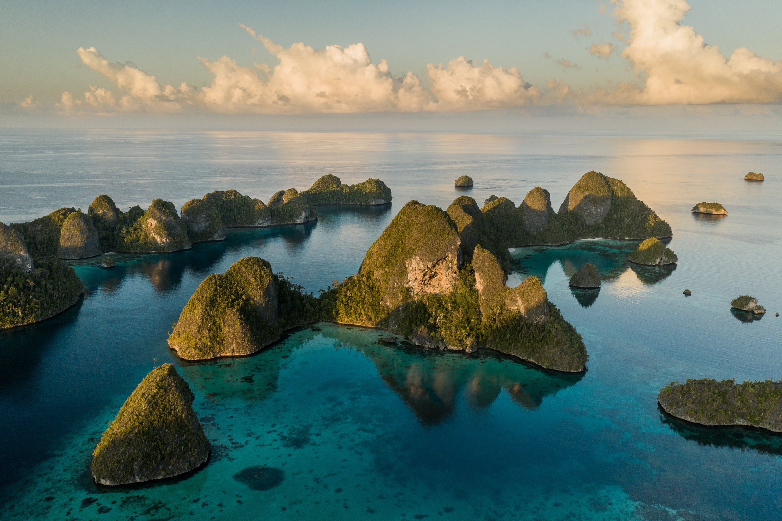 Aerial view of the Wayag lagoon; an uninhabited group of uplifted limestone islands in Raja Ampat, Indonesia. Raja Ampat lies at the heart of the coral triangle - the centre of marine biodiversity on our planet.