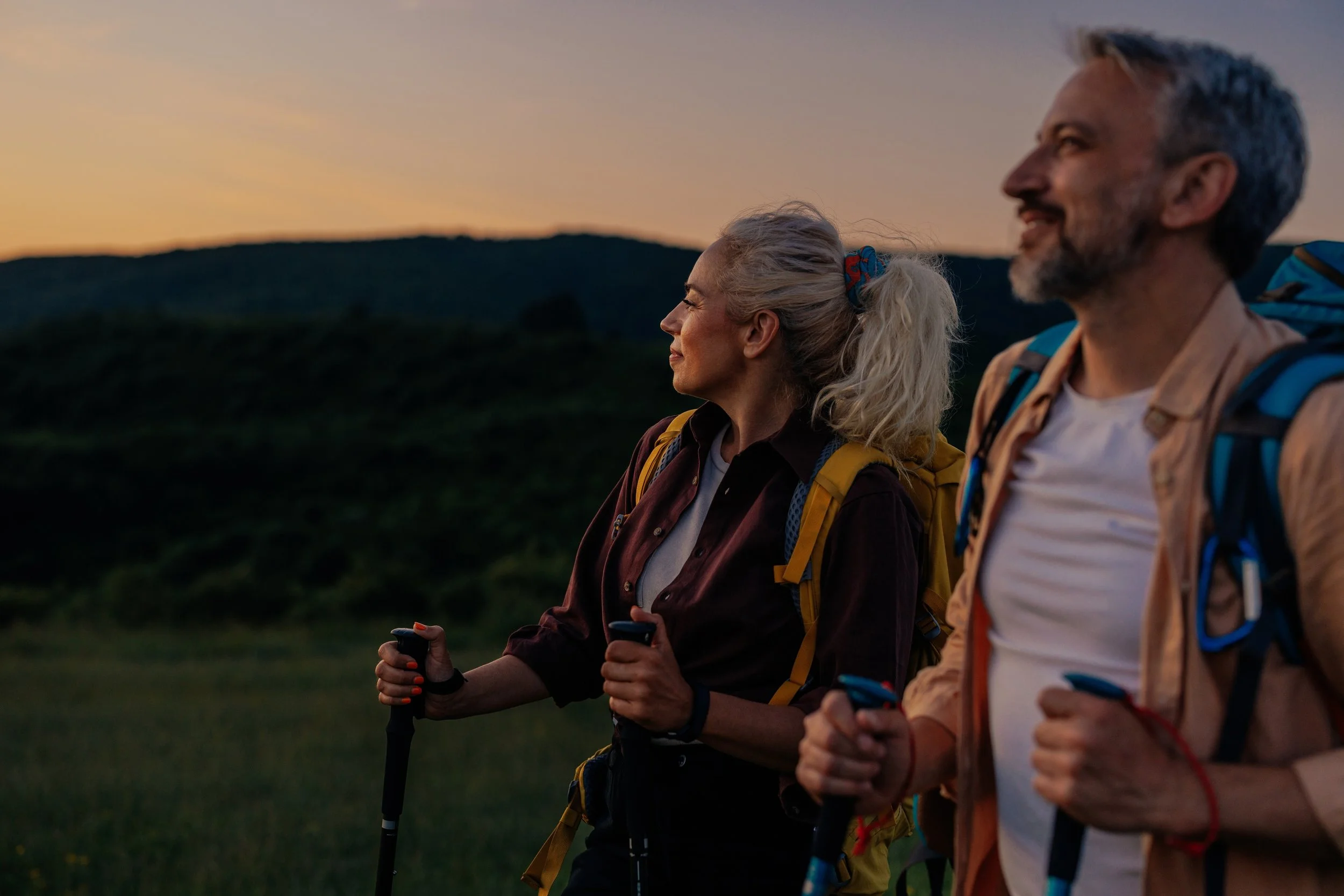 JCIC retired couple reviewing their portfolio remotely while vacationing in a quaint European town