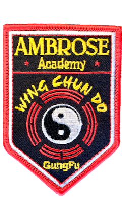 Embroidered Ambrose Academy Patch, red embroidered edge, white inner edge, black background with Ambrose Academy name and Wing Chun Do Logo below.