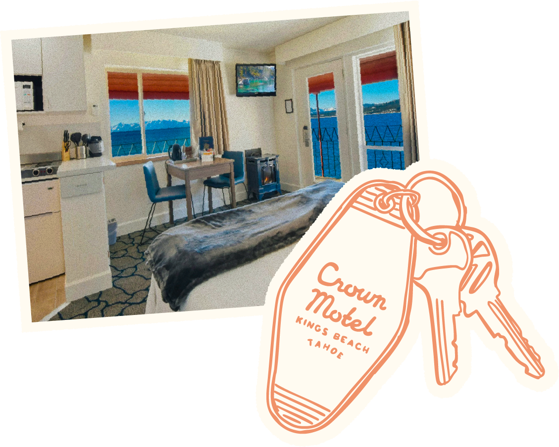 A hotel room with a bed, a dining table with two chairs, large windows showing a view of a lake and mountains, a small stove, and a wall-mounted television. There are also sliding glass doors leading to a balcony and a decorative graphic of a key with a tag labeled 'Crown Motel, Kings Beach, Tahoe'.