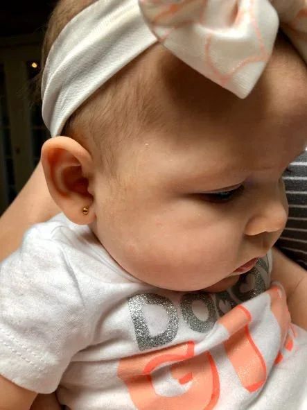 photo with baby wearing earrings.webp