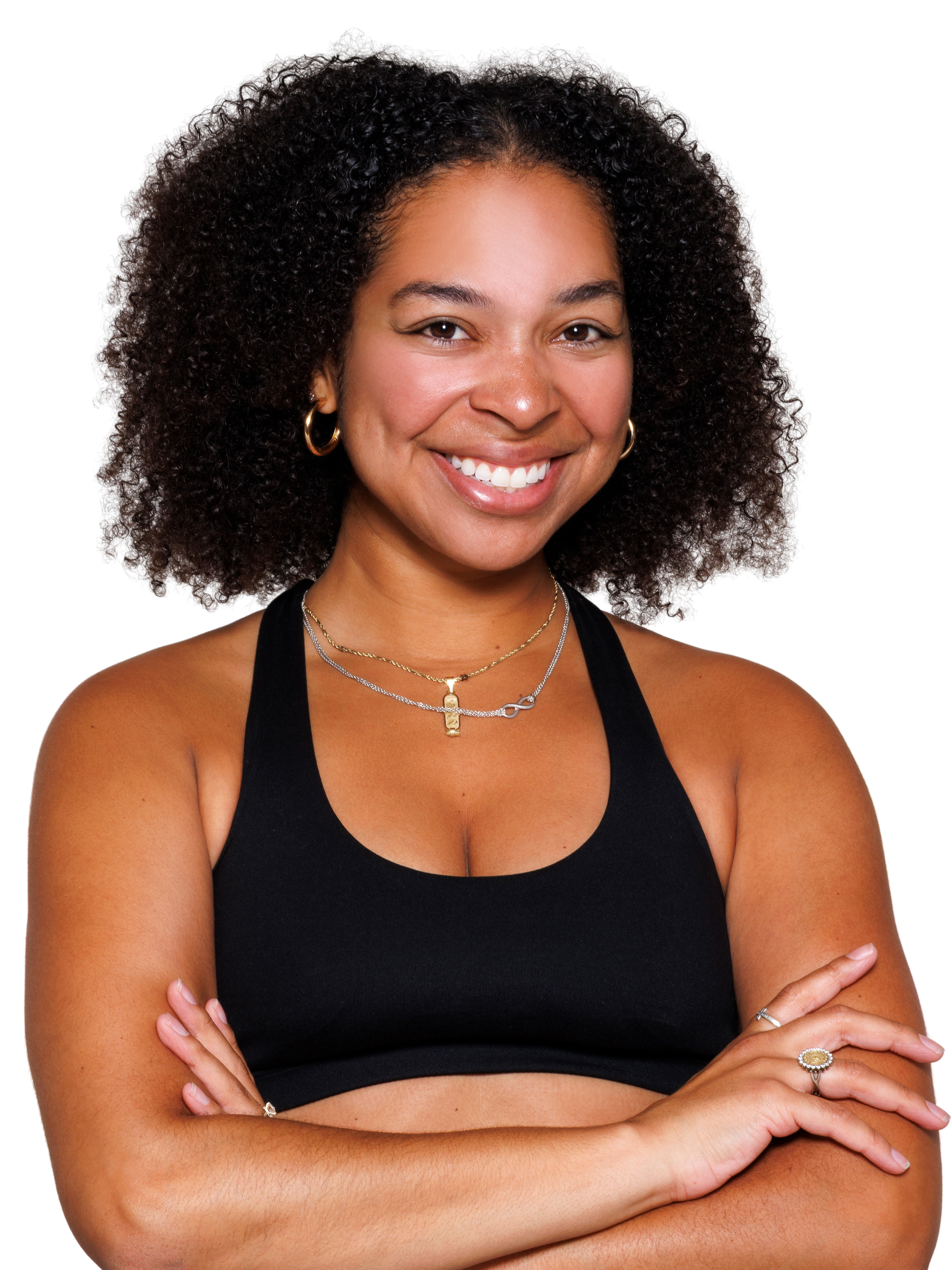 A woman with short, curly hair smiling, wearing a black long-sleeve shirt.