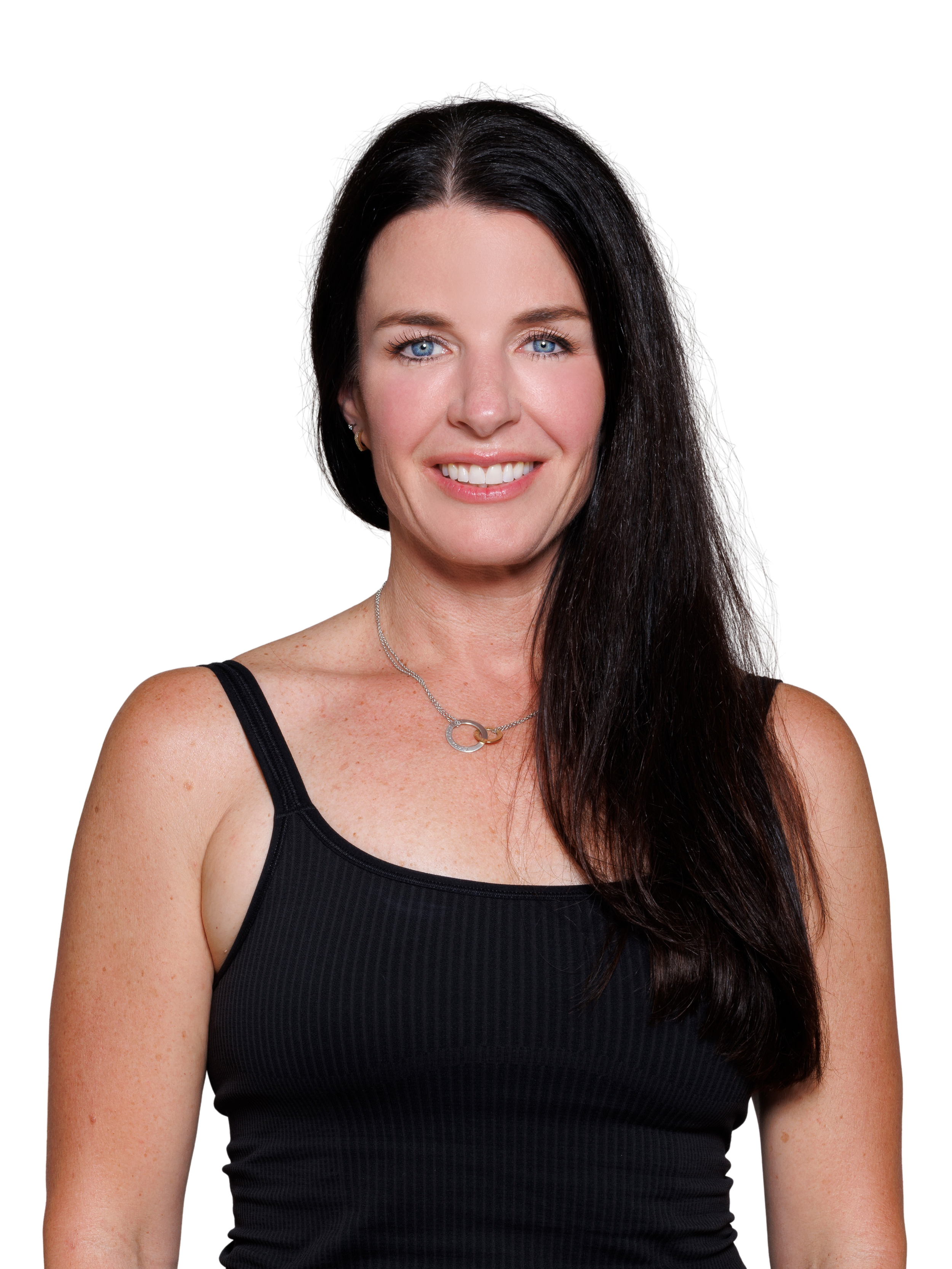 Portrait of a woman with long dark hair, smiling, crossing her arms, wearing a black top and a silver necklace.