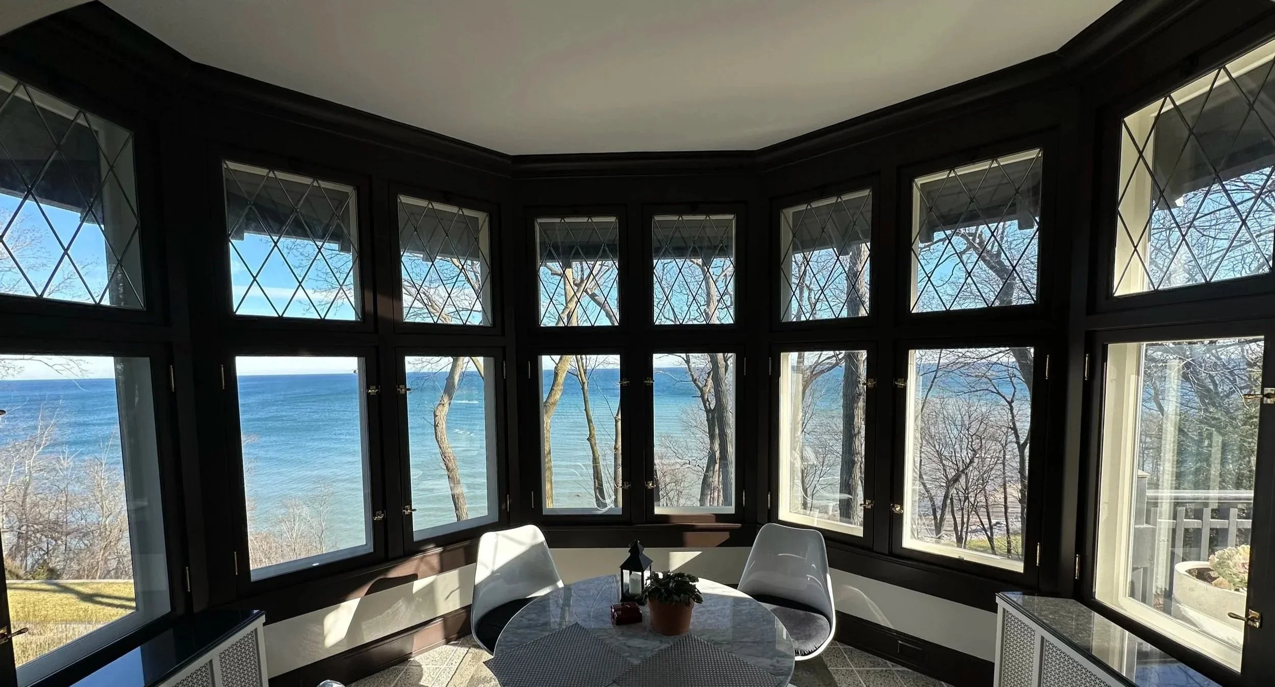 1916 English Revival. Bay window restoration, custom insulated storm windows, and new leaded glass work. Shorewood.