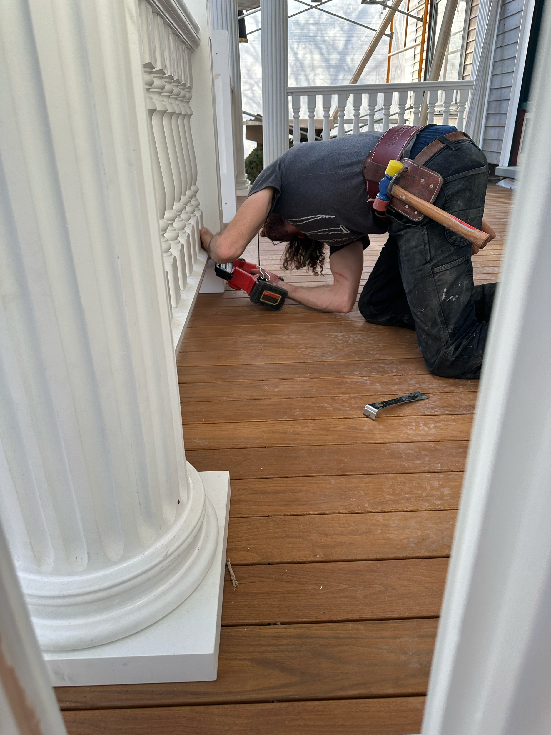 1901 Colonial Revival. Milwaukee. Installing railings and columns on a porch rebuild. 