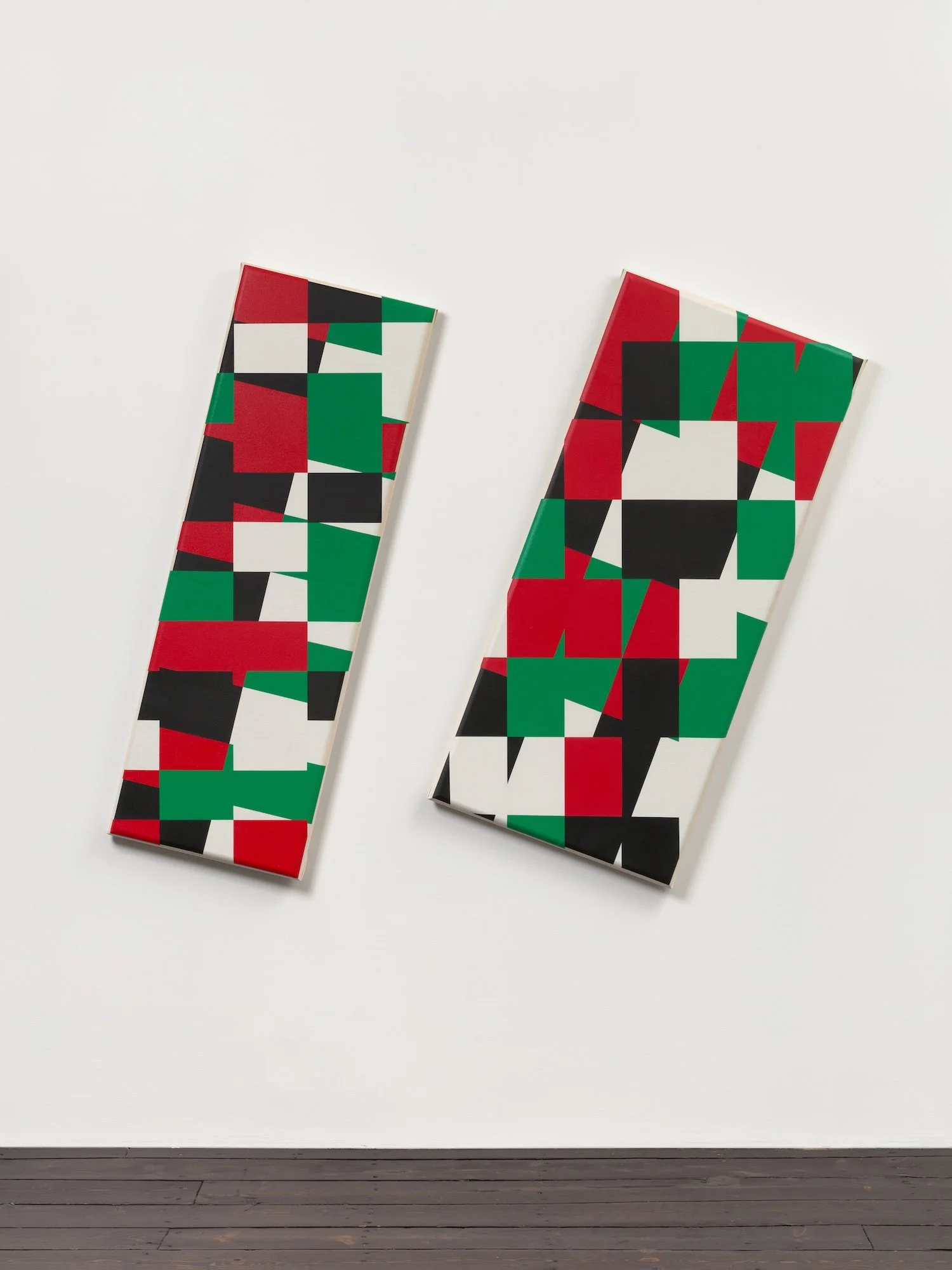 Two long rectangular canvasses with red, green, black, and white in a geometric pattern