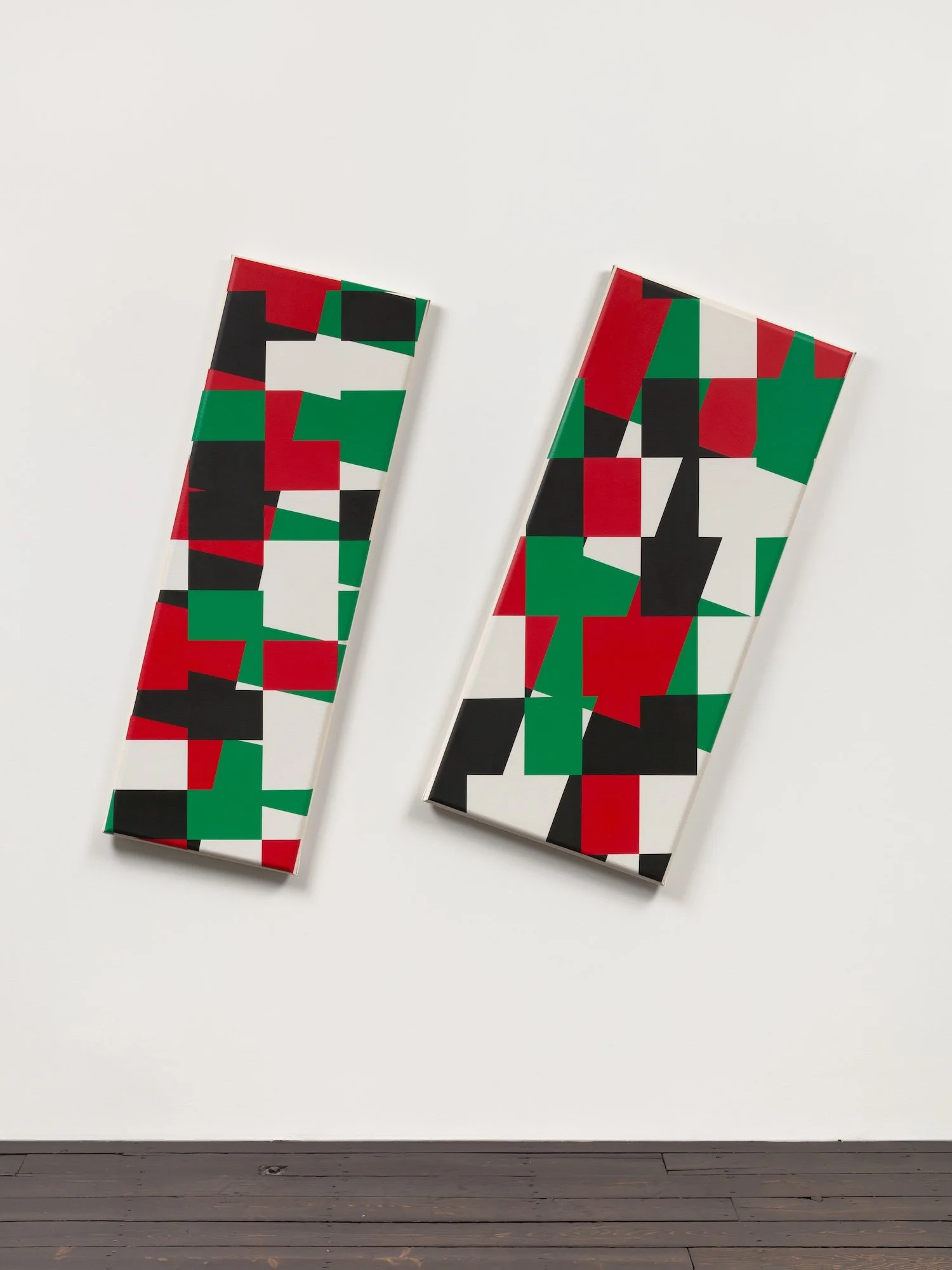 Two long rectangular canvasses with red, green, black, and wite sections in a geometric design.