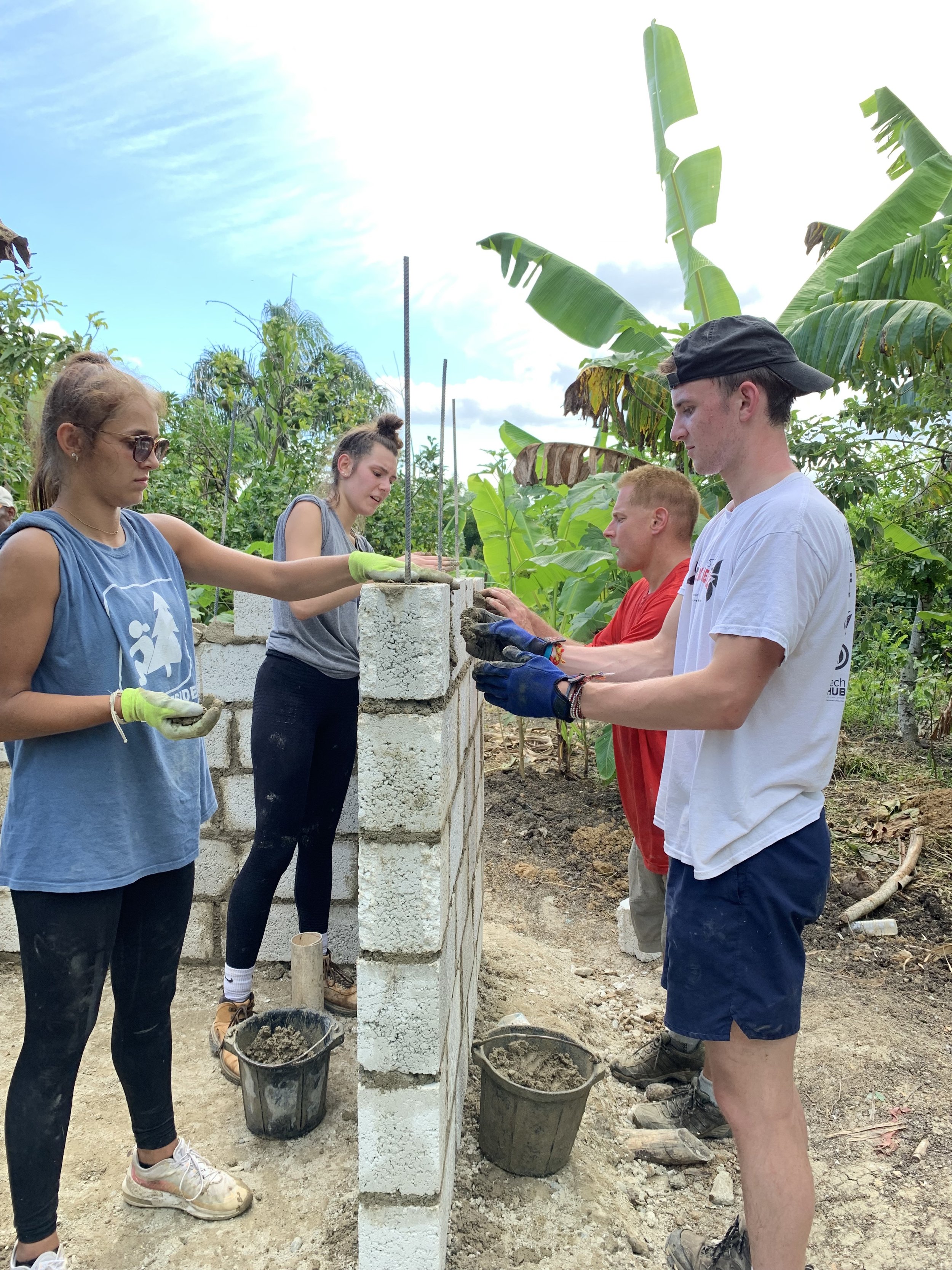 high school students helping build a wall during a service project in the Dominican Republic.jpg