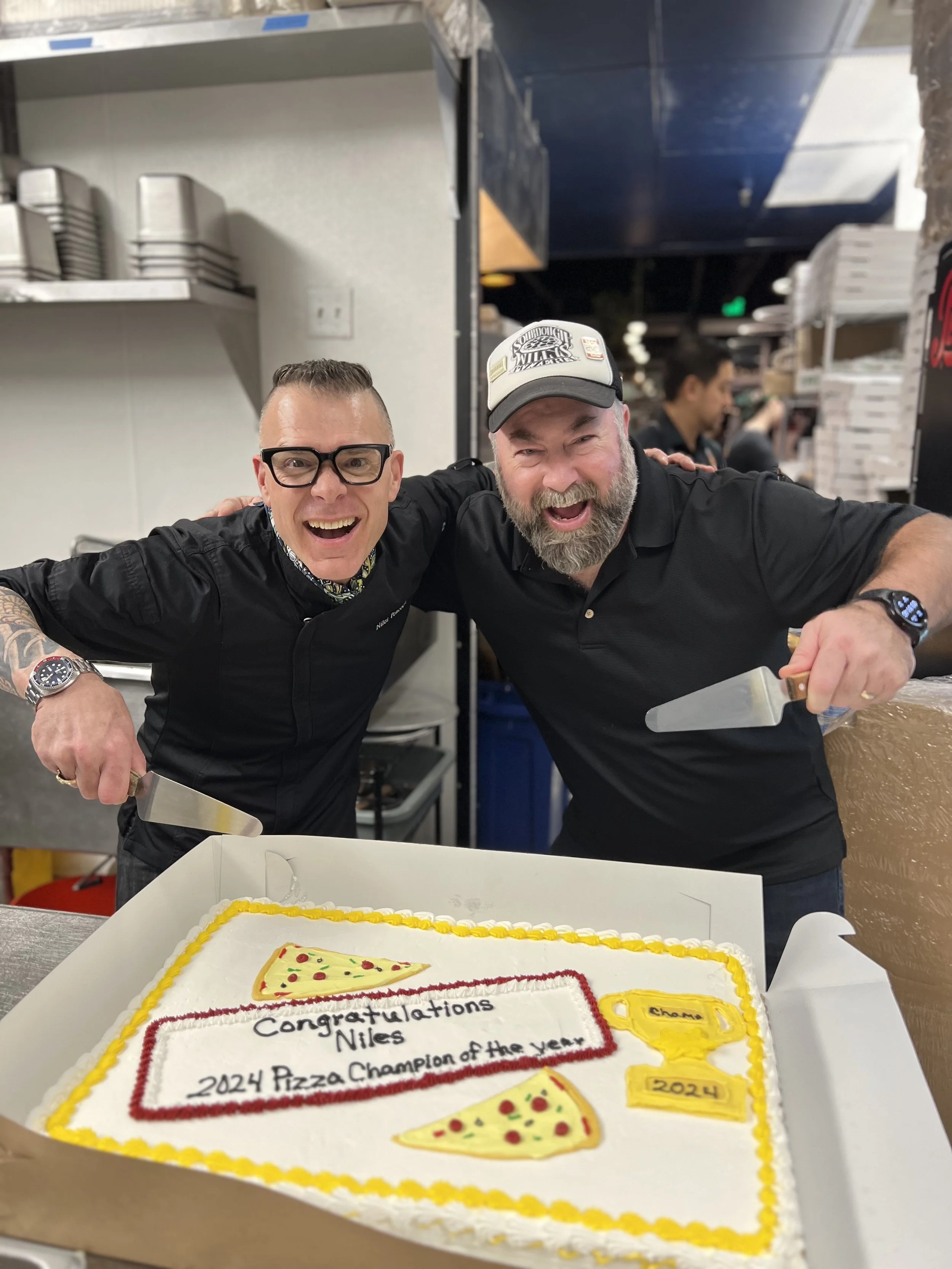 Niles Peacock celebrates with his pizza mentor Will Grant.jpg