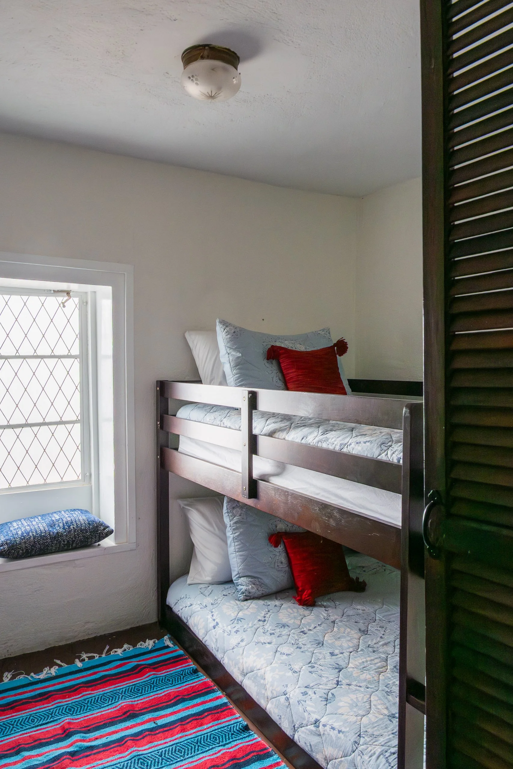 bunk room located next to the utility room, with a half-bath
