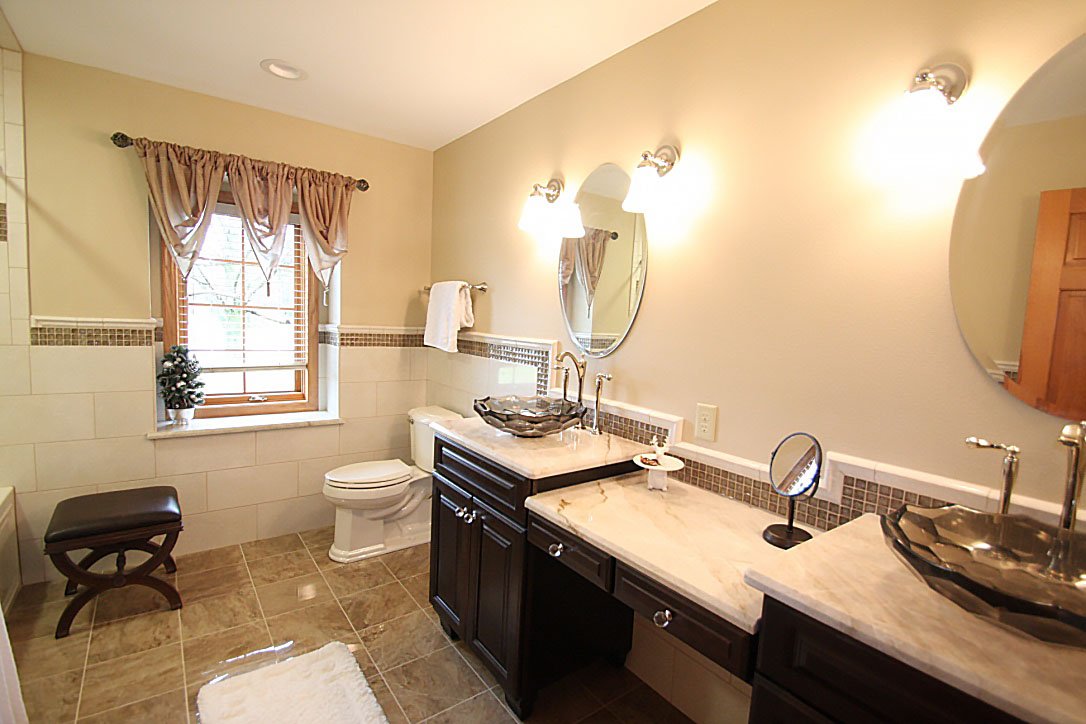 Marble vanity vessel sinks in bathroom.
