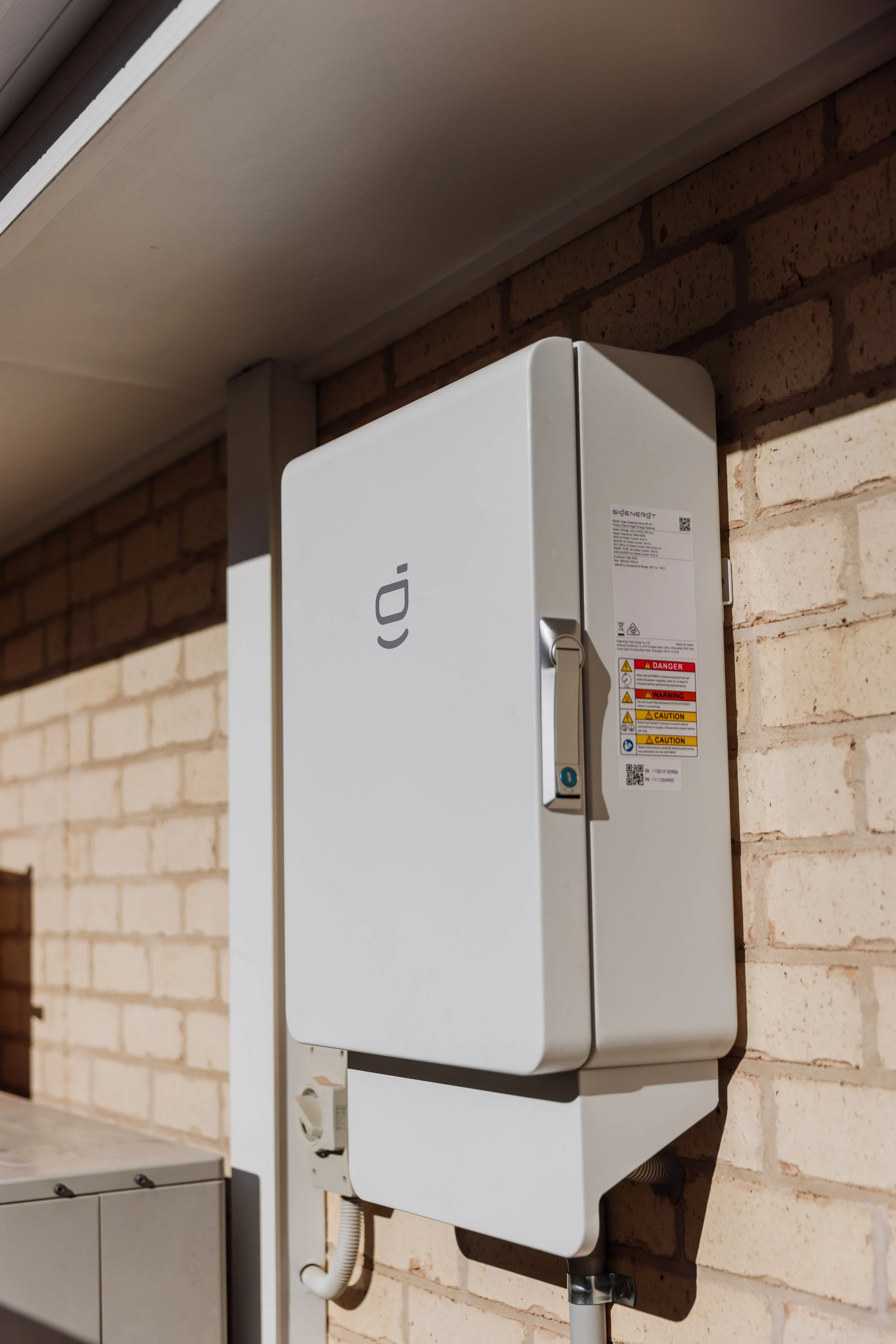 Home battery installed on brick wall