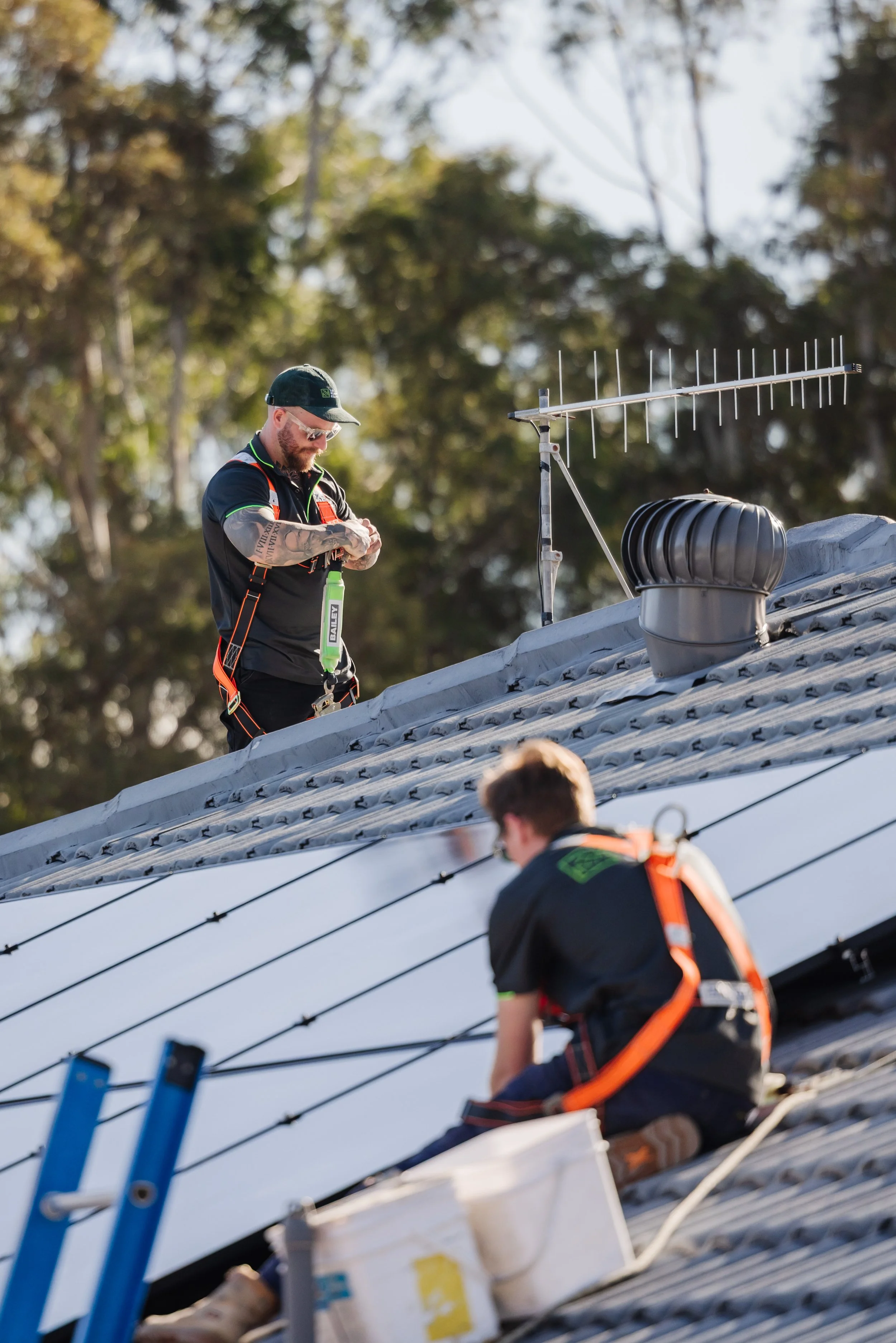 Electricians on roof installing solar