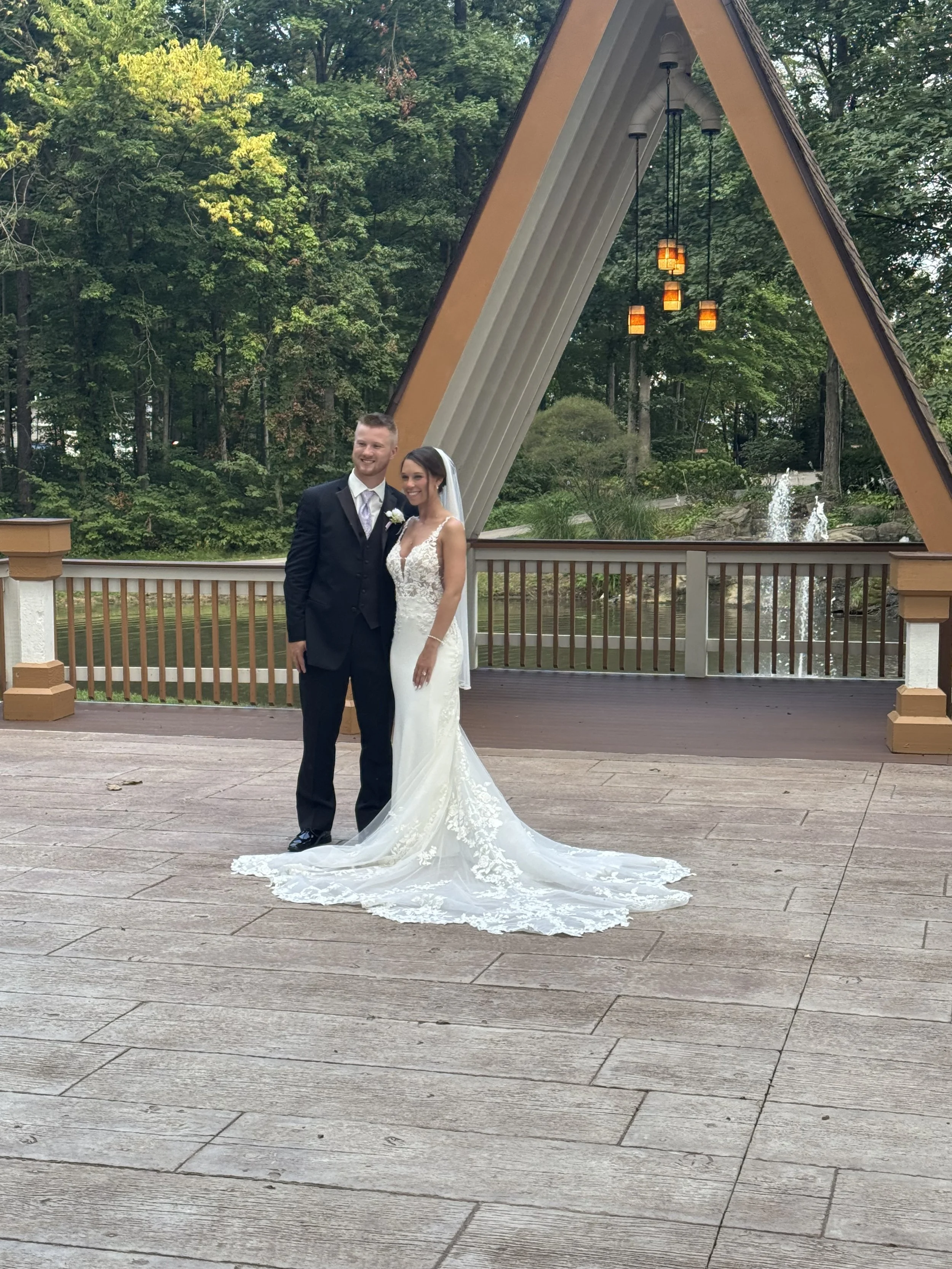 Luxury outdoor wedding venue with smiling bride and groom getting their photos taken