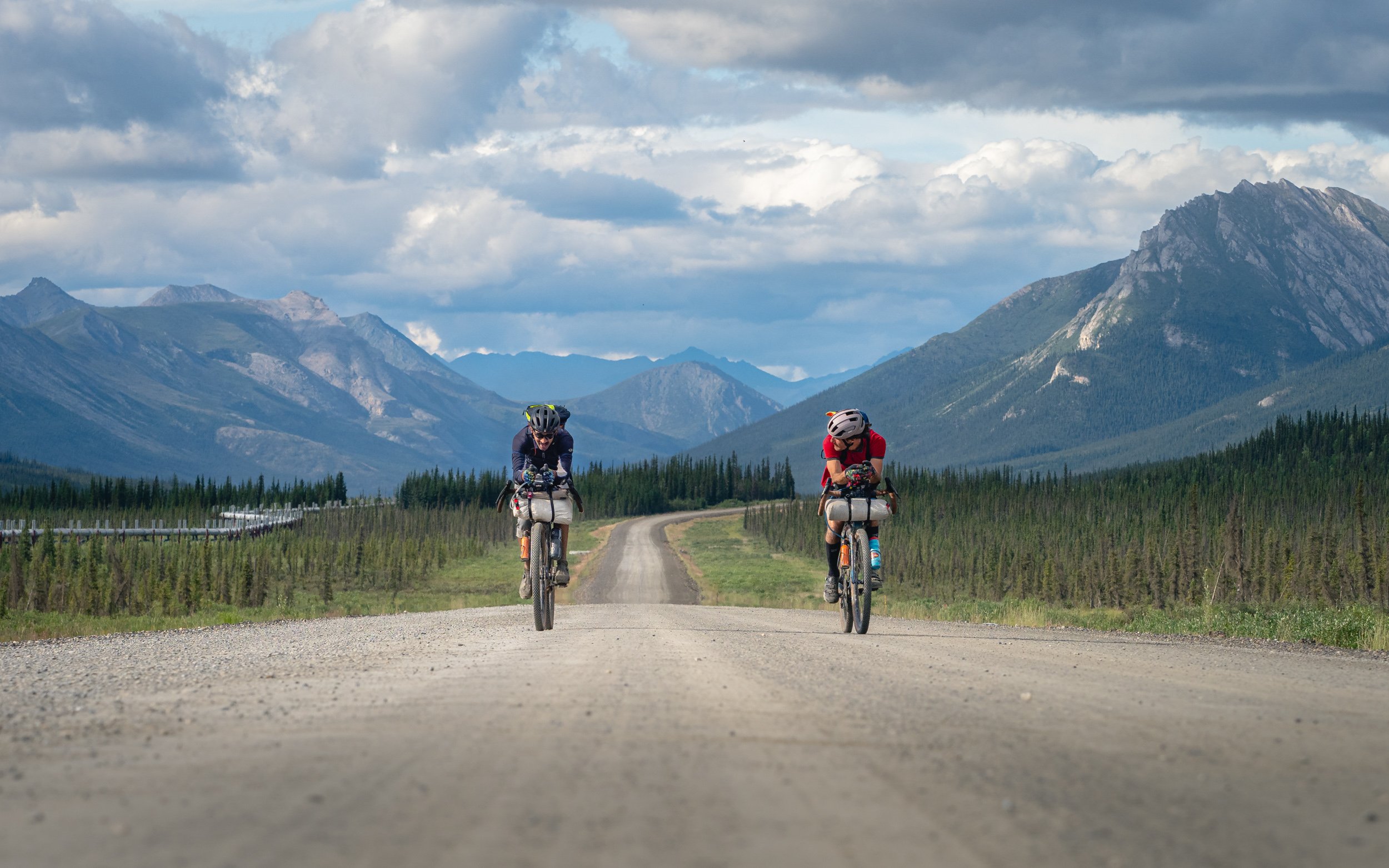 Bikepacking the Dalton Highway north of the Arctic Circle, Trans Alaskan Pipeline to the left, Alaska