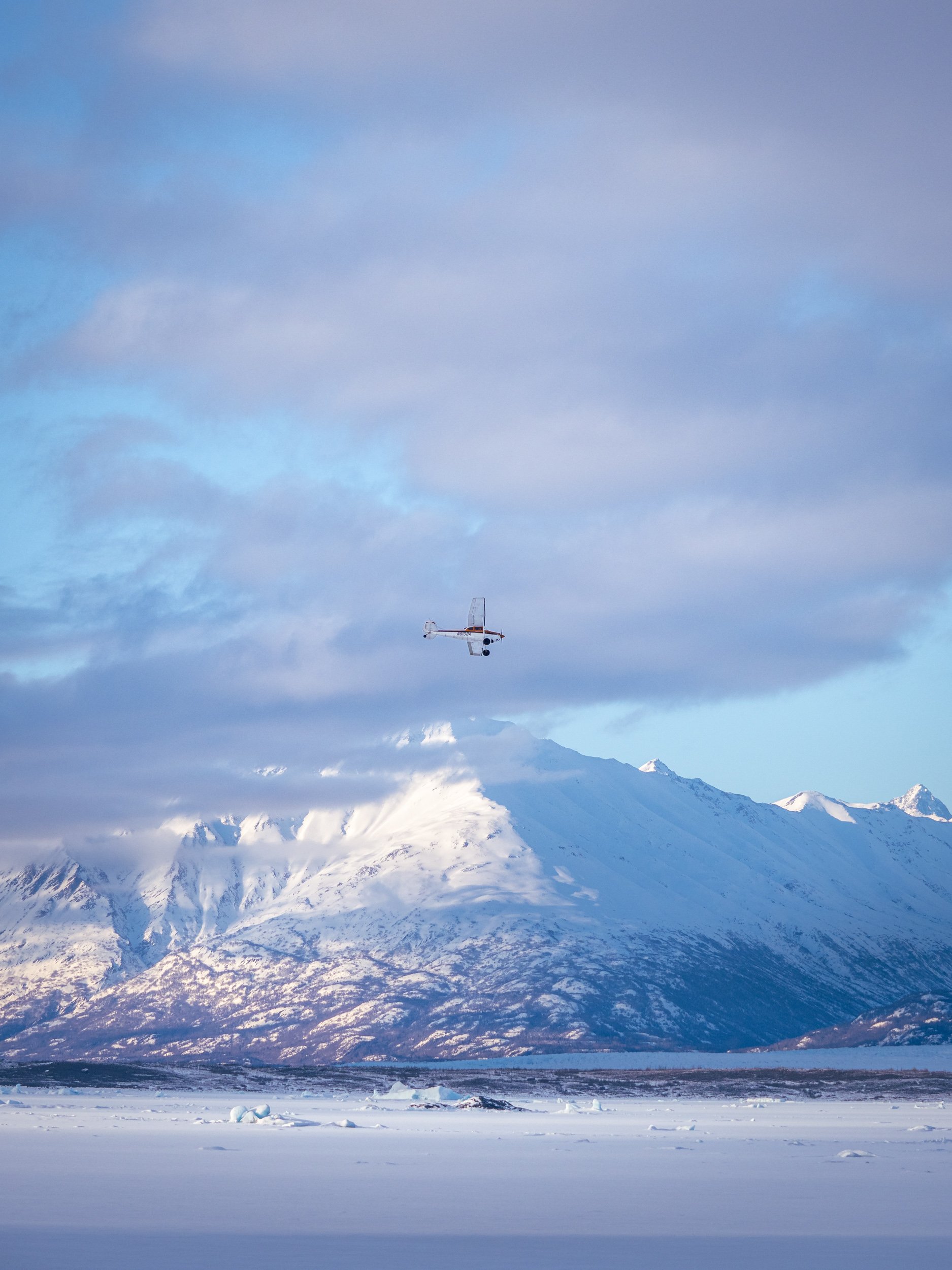 Bush plane flies over the Knik Glacier, Alaska