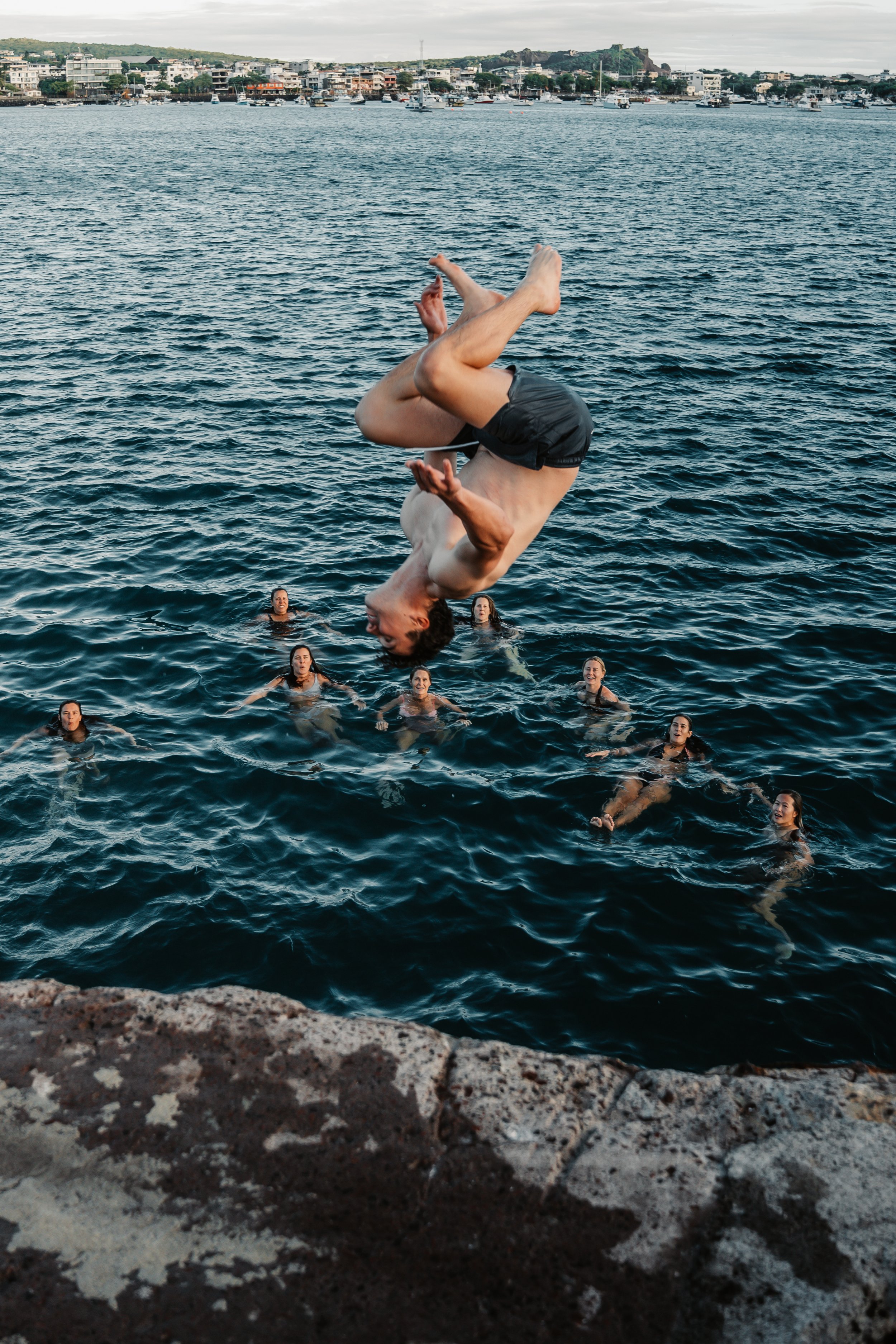 Galápagos freediving expedition San Cristóbal backflips off a secret local spot.