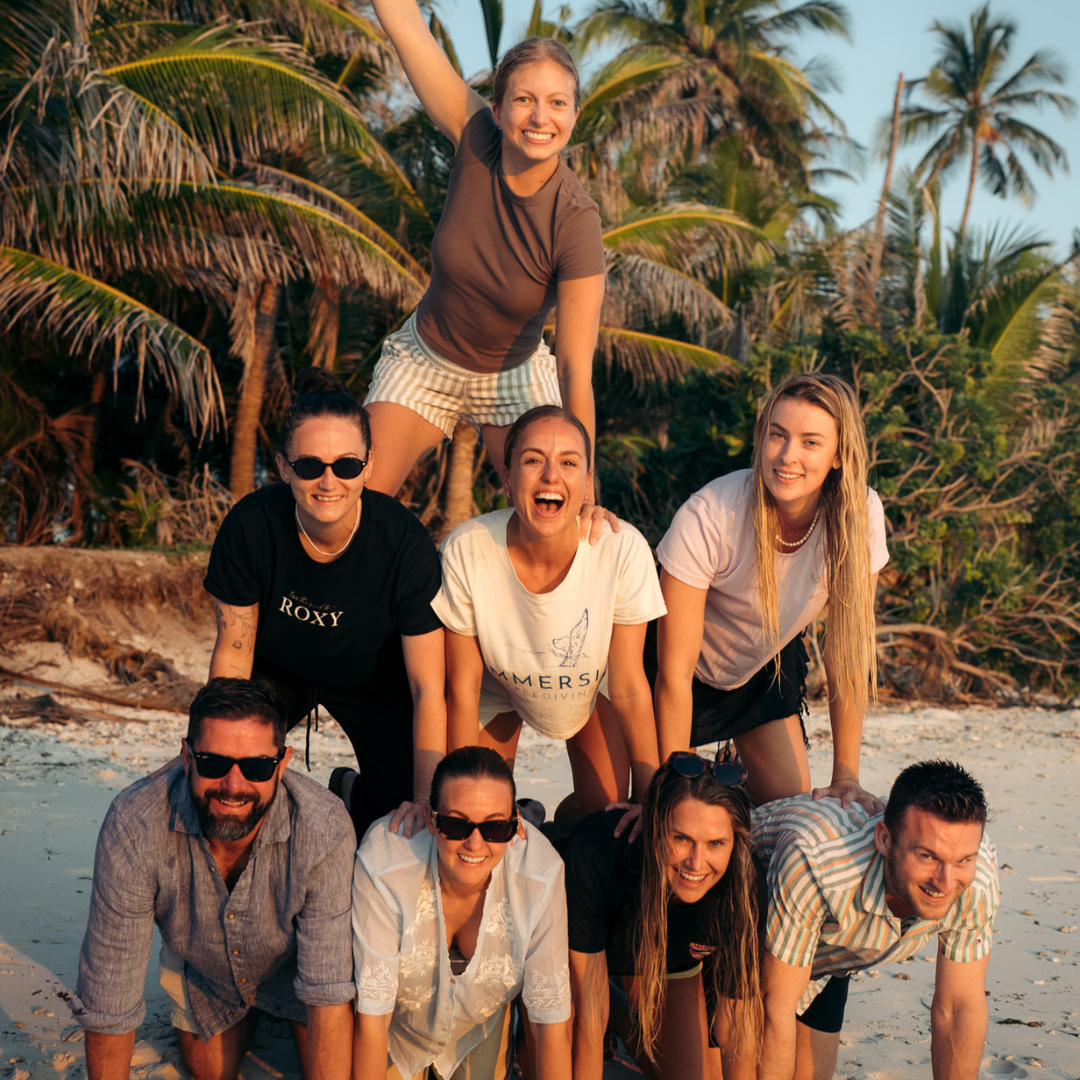 Guests on a freediving expedition in a human pyramid