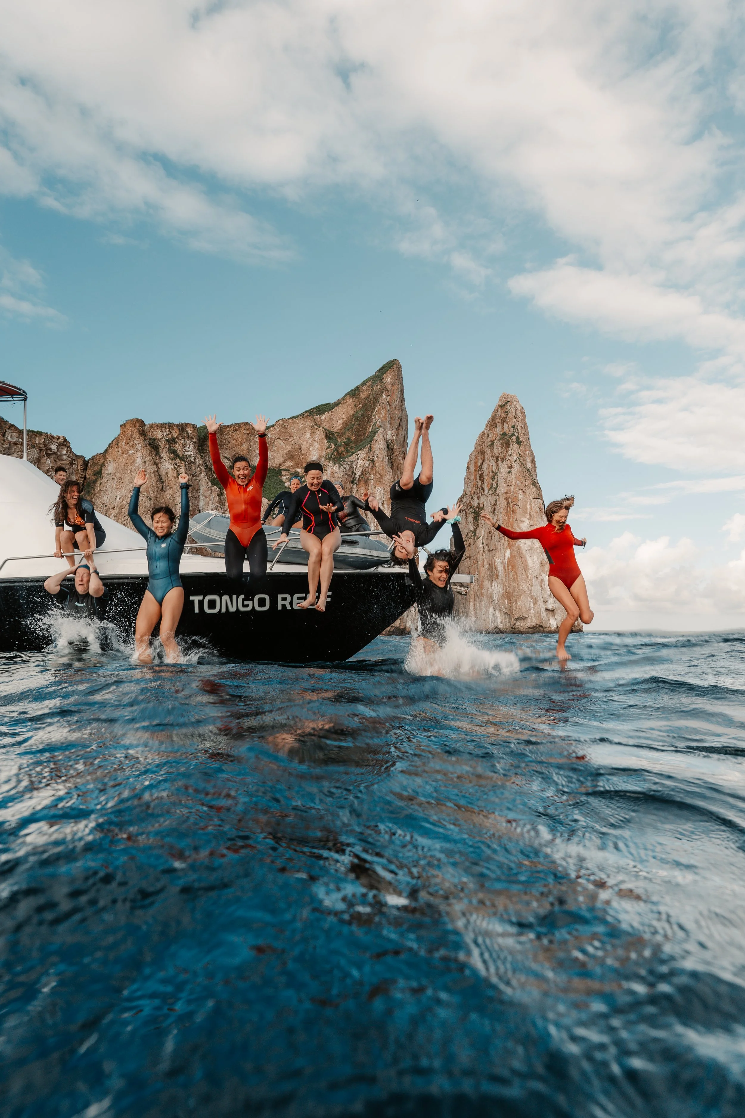 Galápagos freediving expedition San Cristóbal people jumping off a boat.