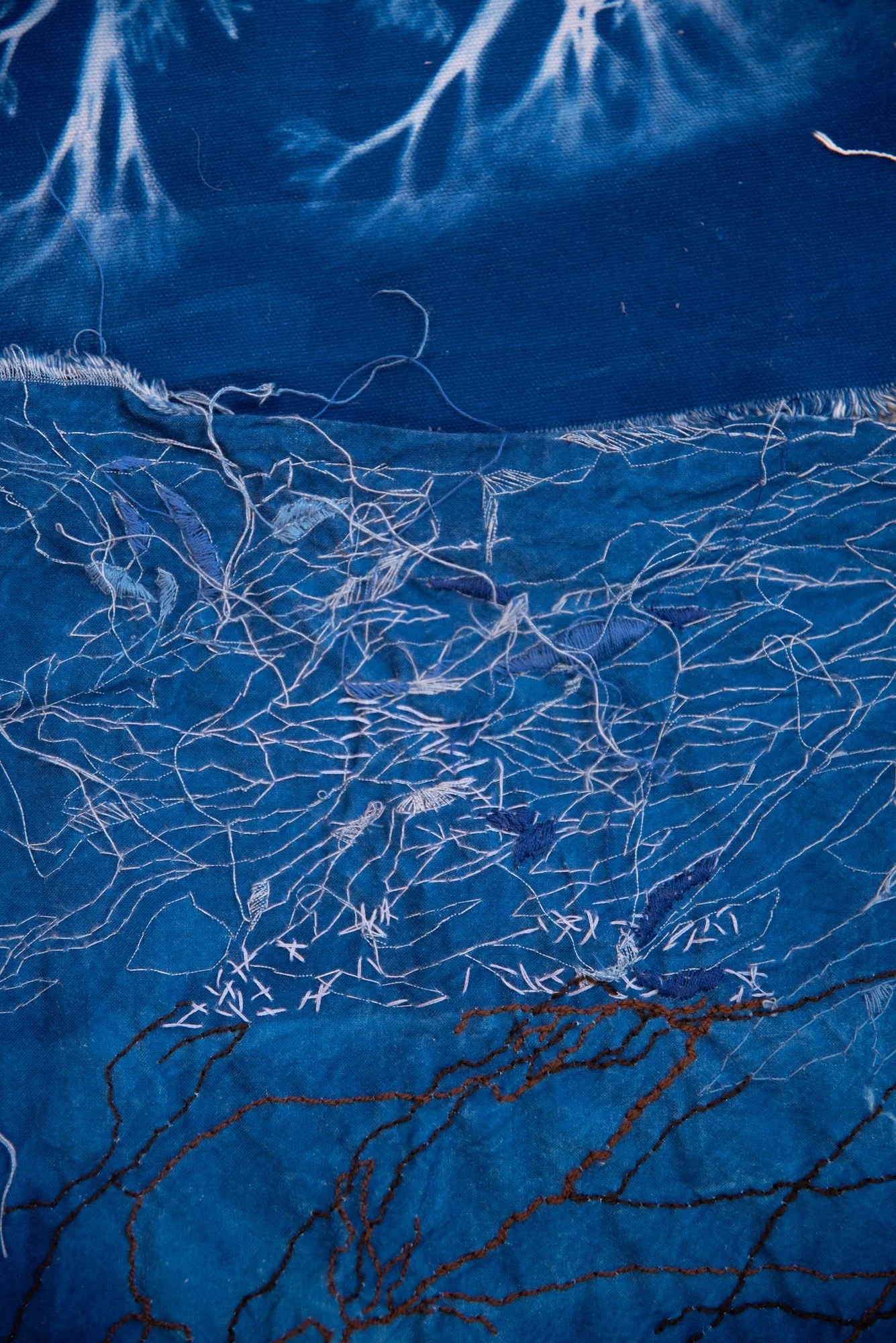 Sceneteppe til Ringerike fengsel, avdeling Ullersmo, i samarbeid med en gruppe innsatte. Teknikk og materiale: Cyanotype på tekstilbiter i bomull, lin, silke og ull, broderi i ull, silke og bomull, applikert på kraftig bomullstekstil. Håndsøm. Fôret 