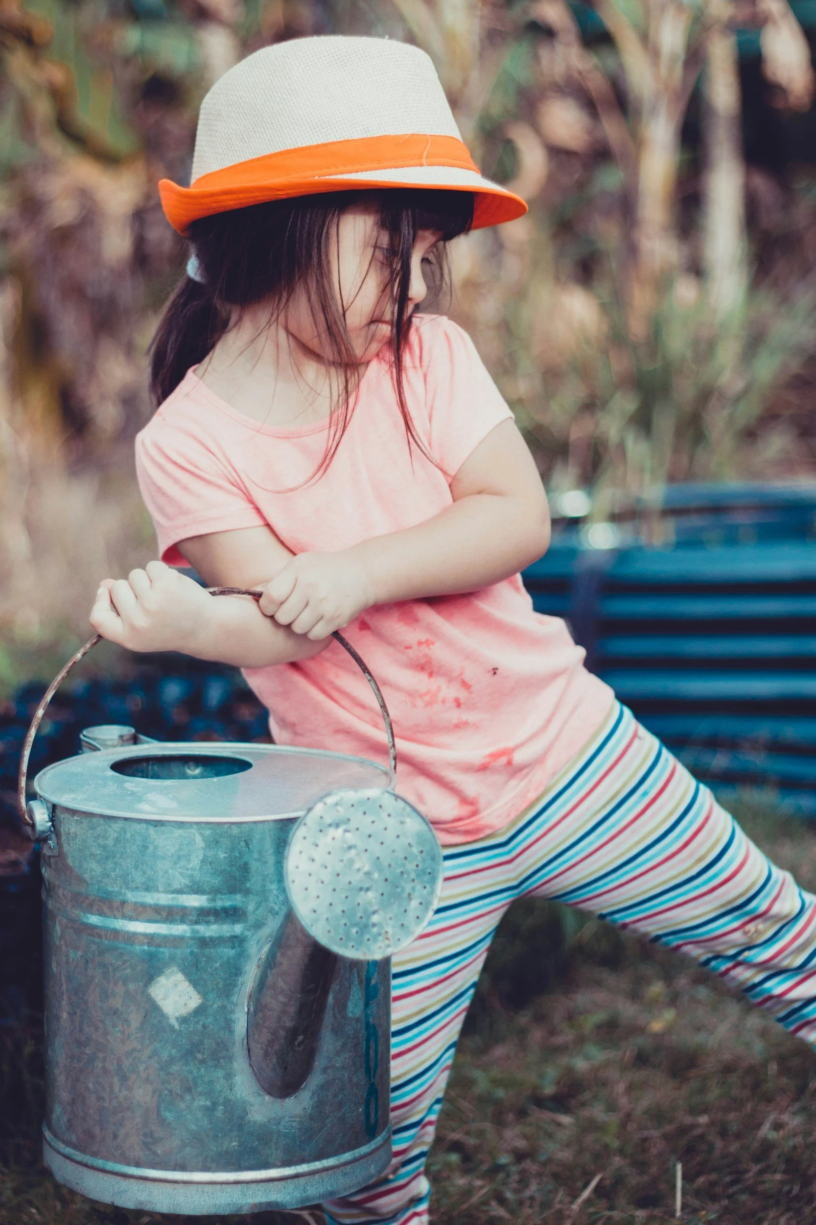 child with watering can