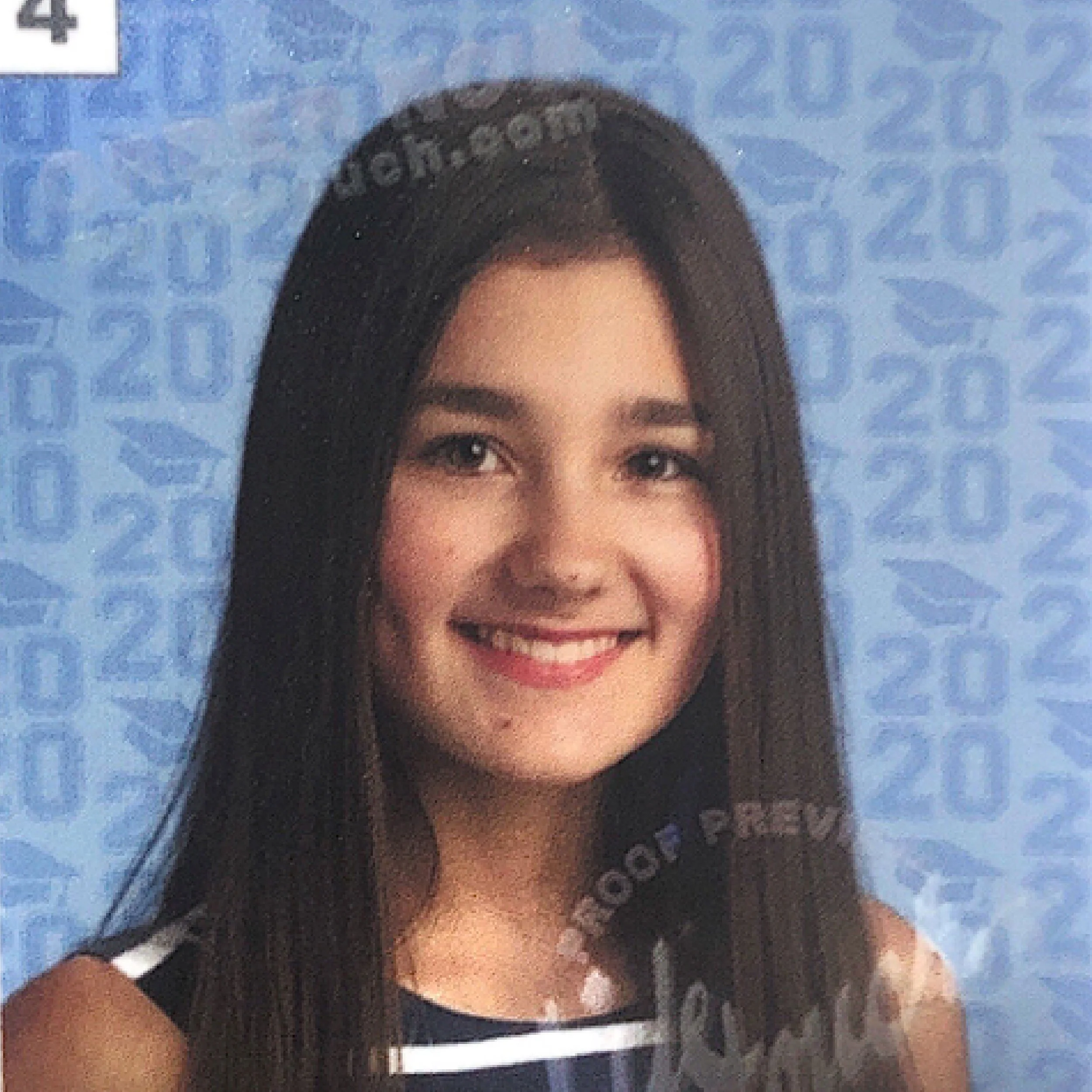 A young woman smiling, with long dark hair, in front of a blue background with numbers.