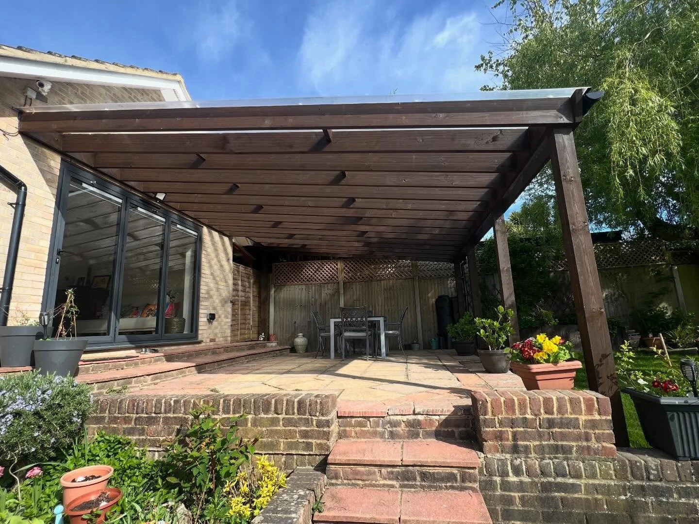We completed a similar project last year utilizing large lengths of treated timber measuring 5.4 meters by 8 inches by 2 inches. The structure was supported by a substantial house wall plate and four sturdy posts measuring 5 inches by 5 inches to ade