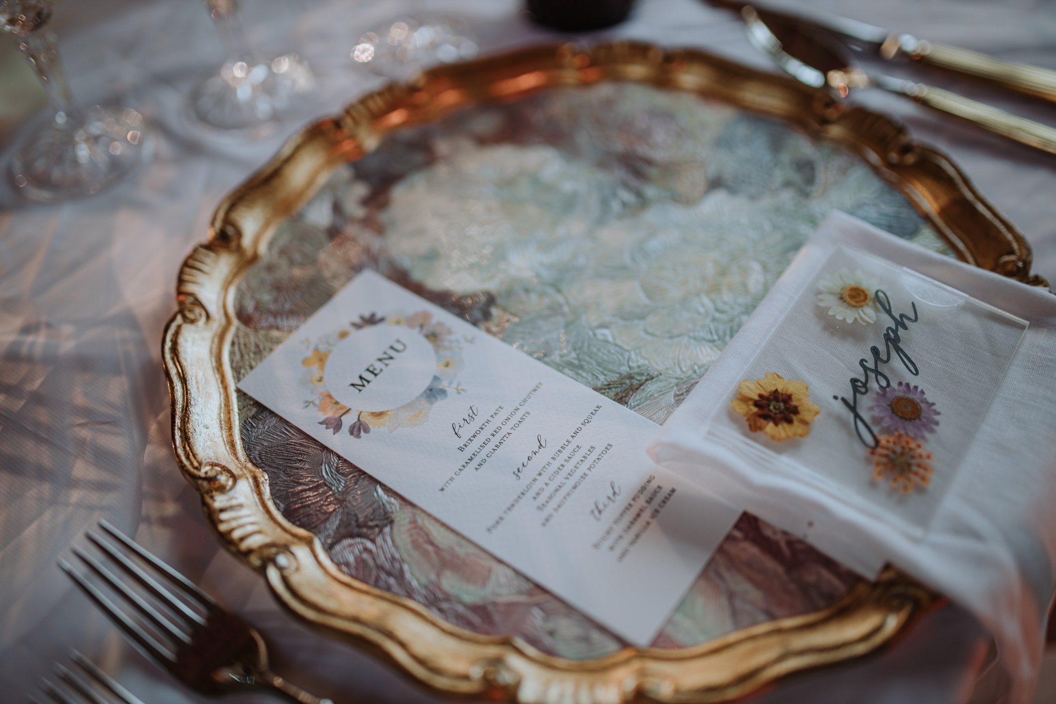 Floral wedding breakfast menu on floral charger plate