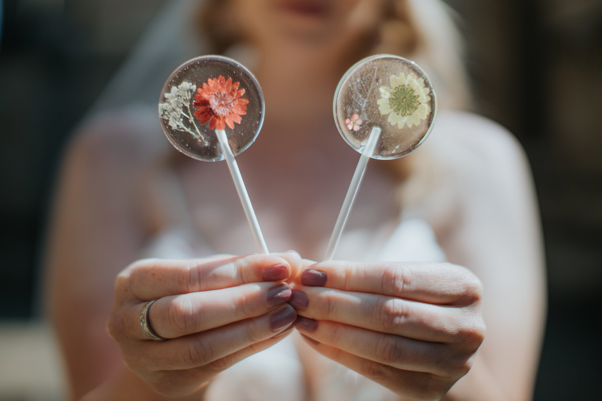 Bride holding lollipops