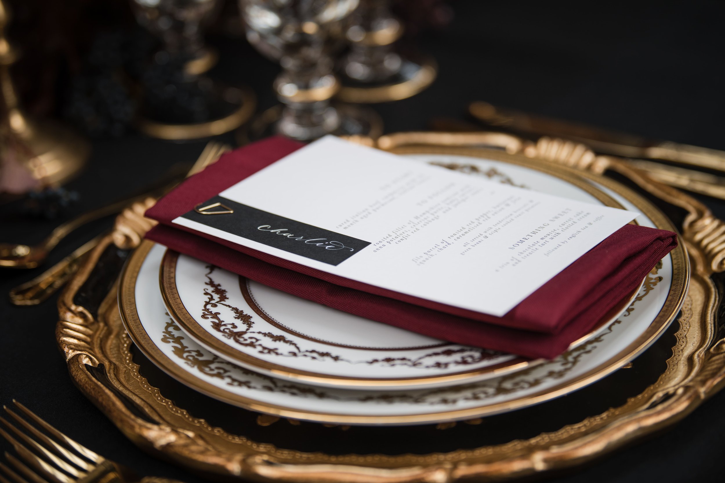 Black and gold place setting with menu