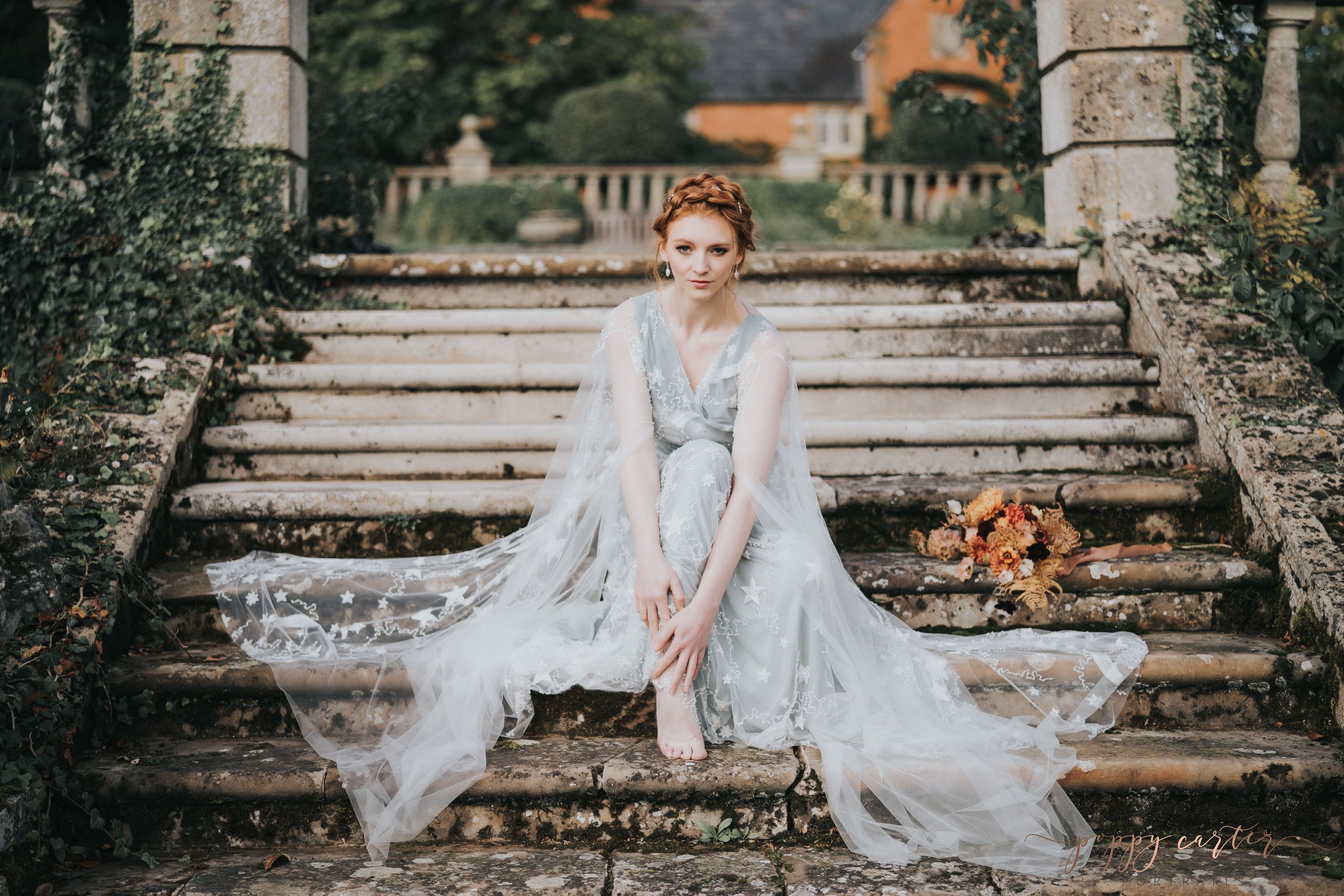 Stunning bride in blue sitting on stone steps